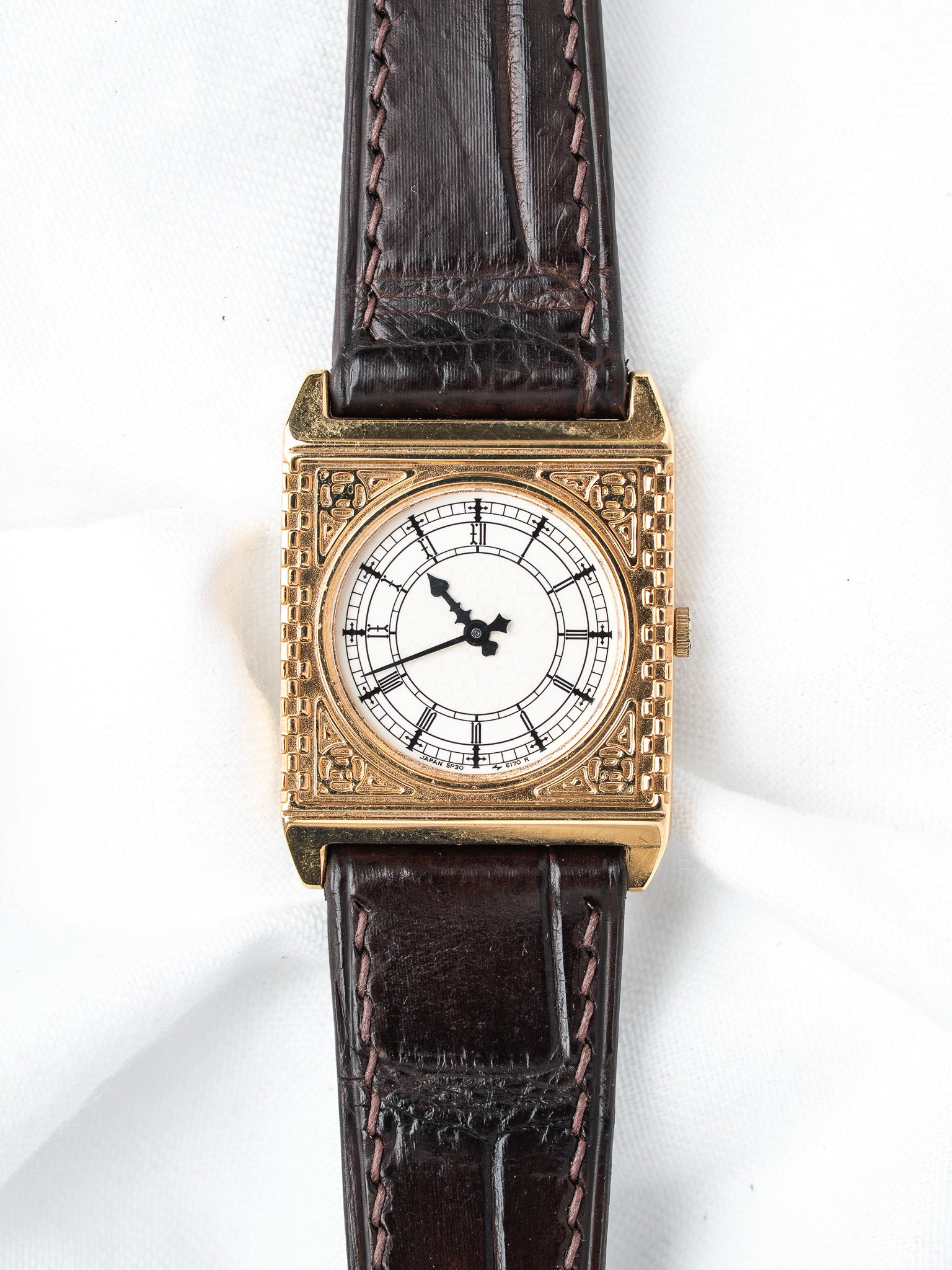 Vintage Seiko square gold case watch with white dial, black hands, brown leather strap