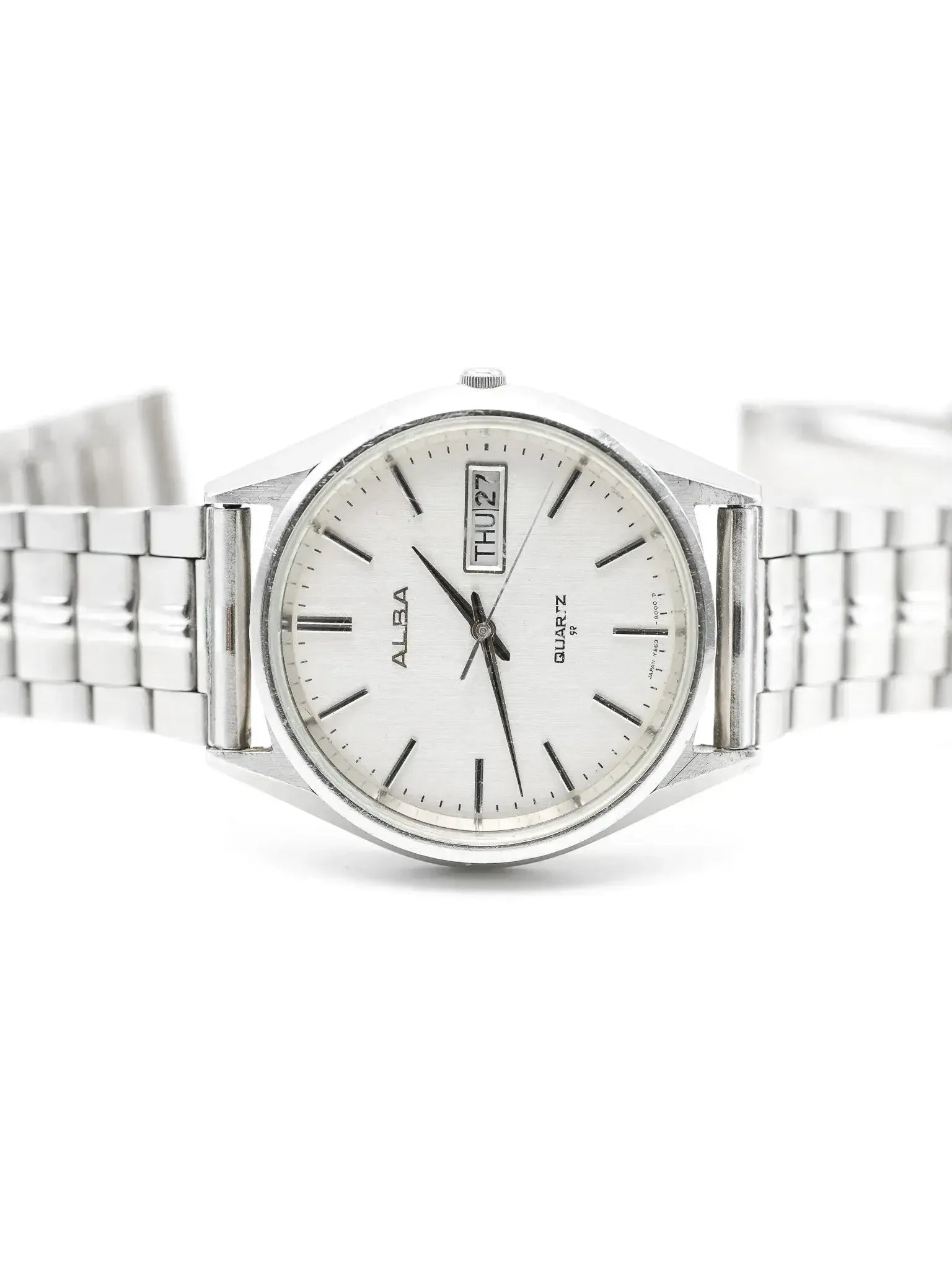 Alba vintage quartz watch with silver dial, day-date window, and steel bracelet on white background