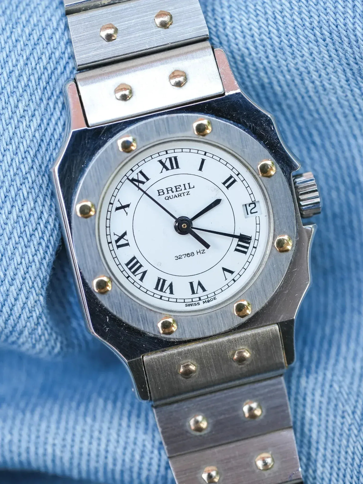 Breil Quartz vintage watch with white dial, Roman numerals, steel case and bracelet on denim
