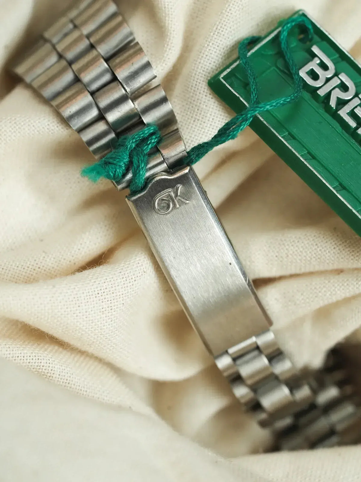 Bulova vintage watch bracelet with engraved clasp, steel links, green tag attached