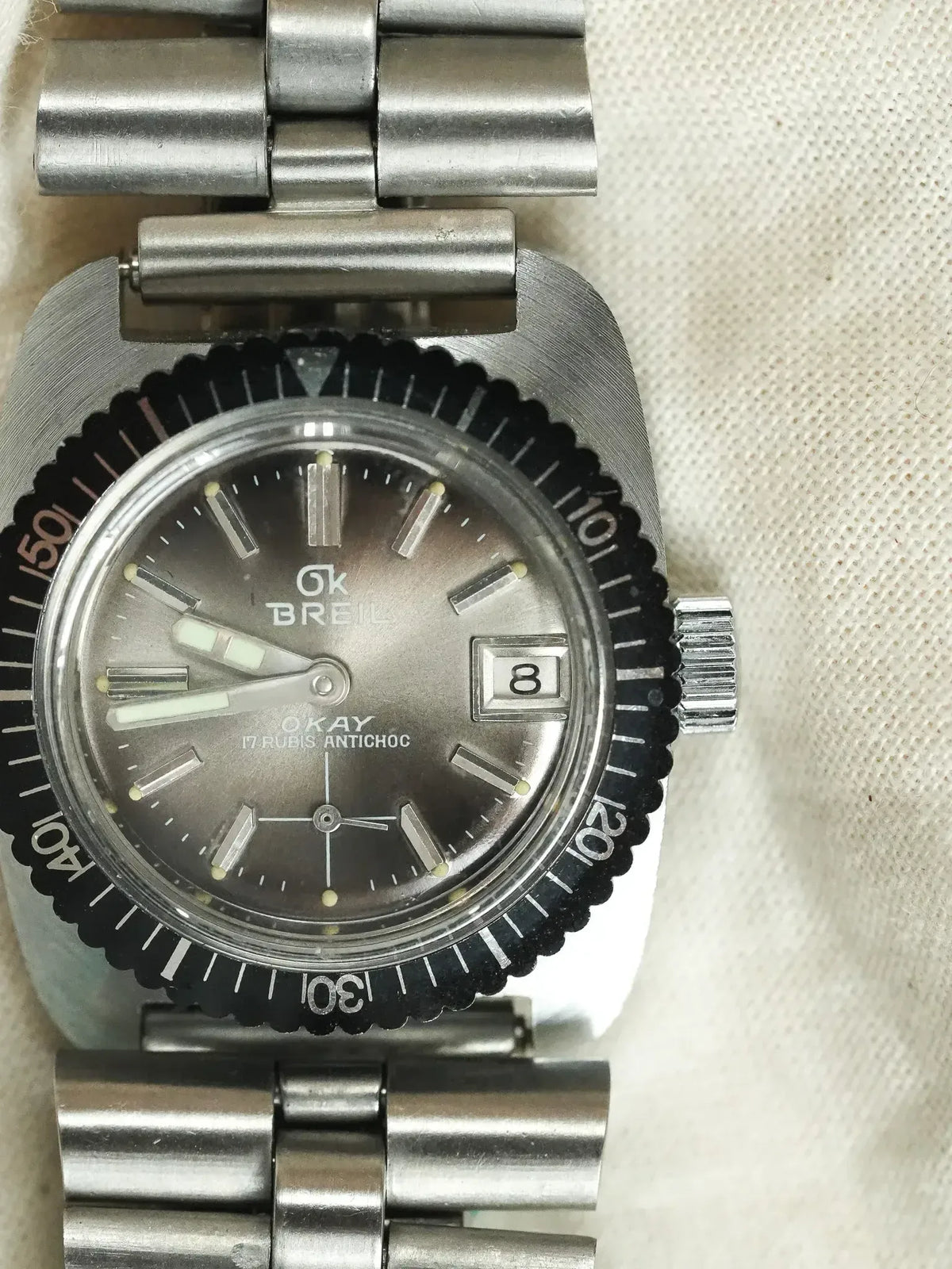 GK Breil Okay vintage watch with grey dial, black bezel, steel bracelet on fabric