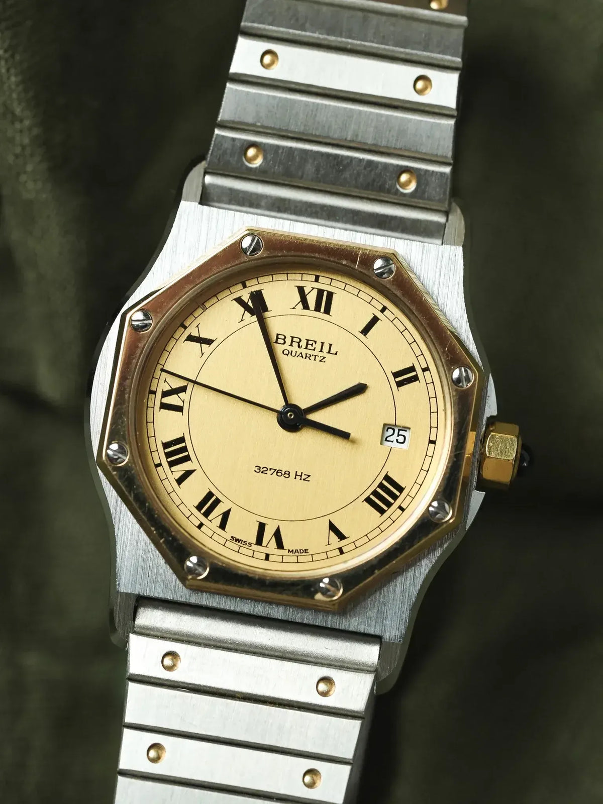 Breil quartz watch with octagonal case, cream dial, Roman numerals, and two-tone metal bracelet