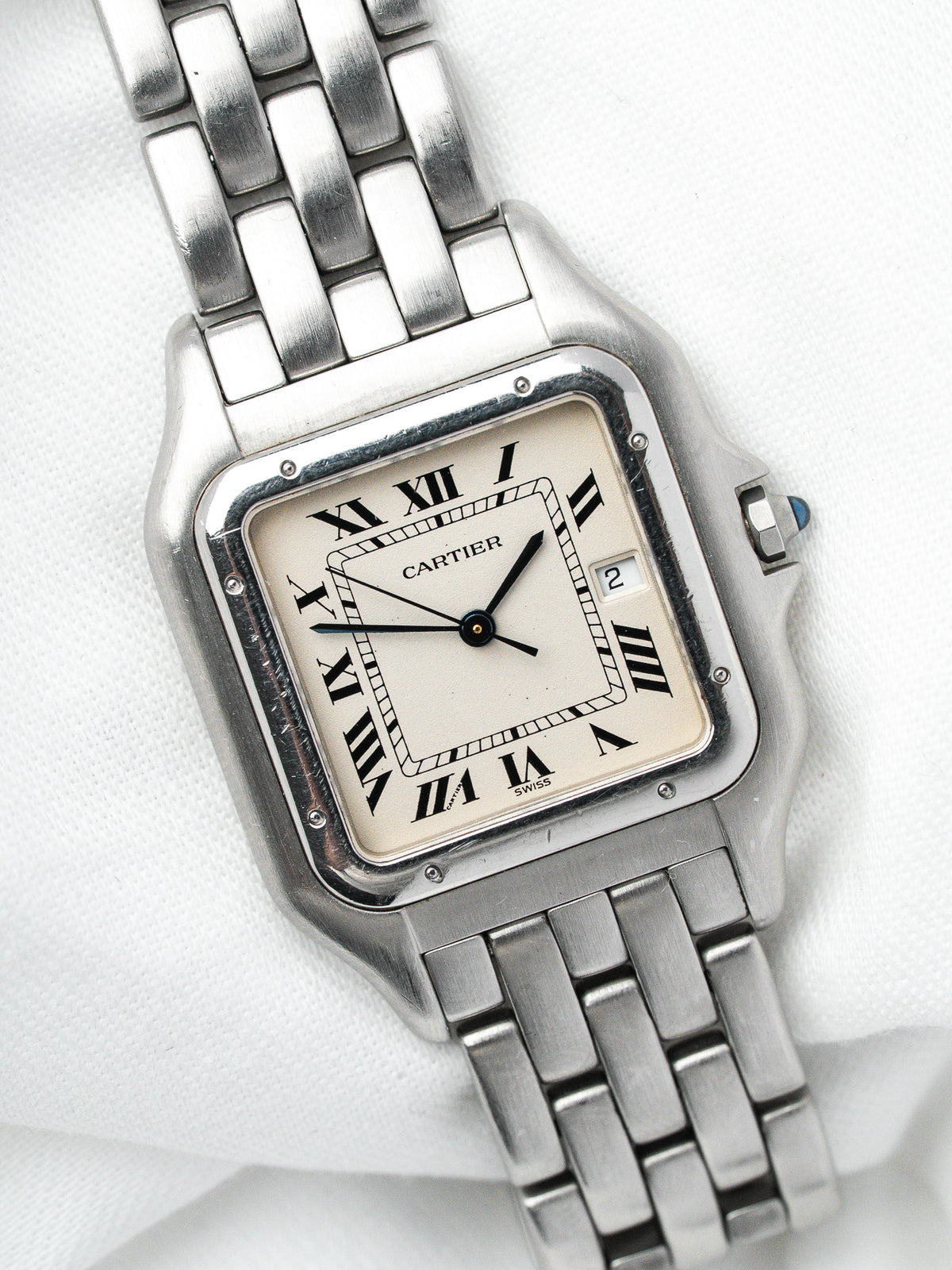 Montre Cartier vintage en acier, boîtier rectangulaire, cadran blanc et bracelet métallique