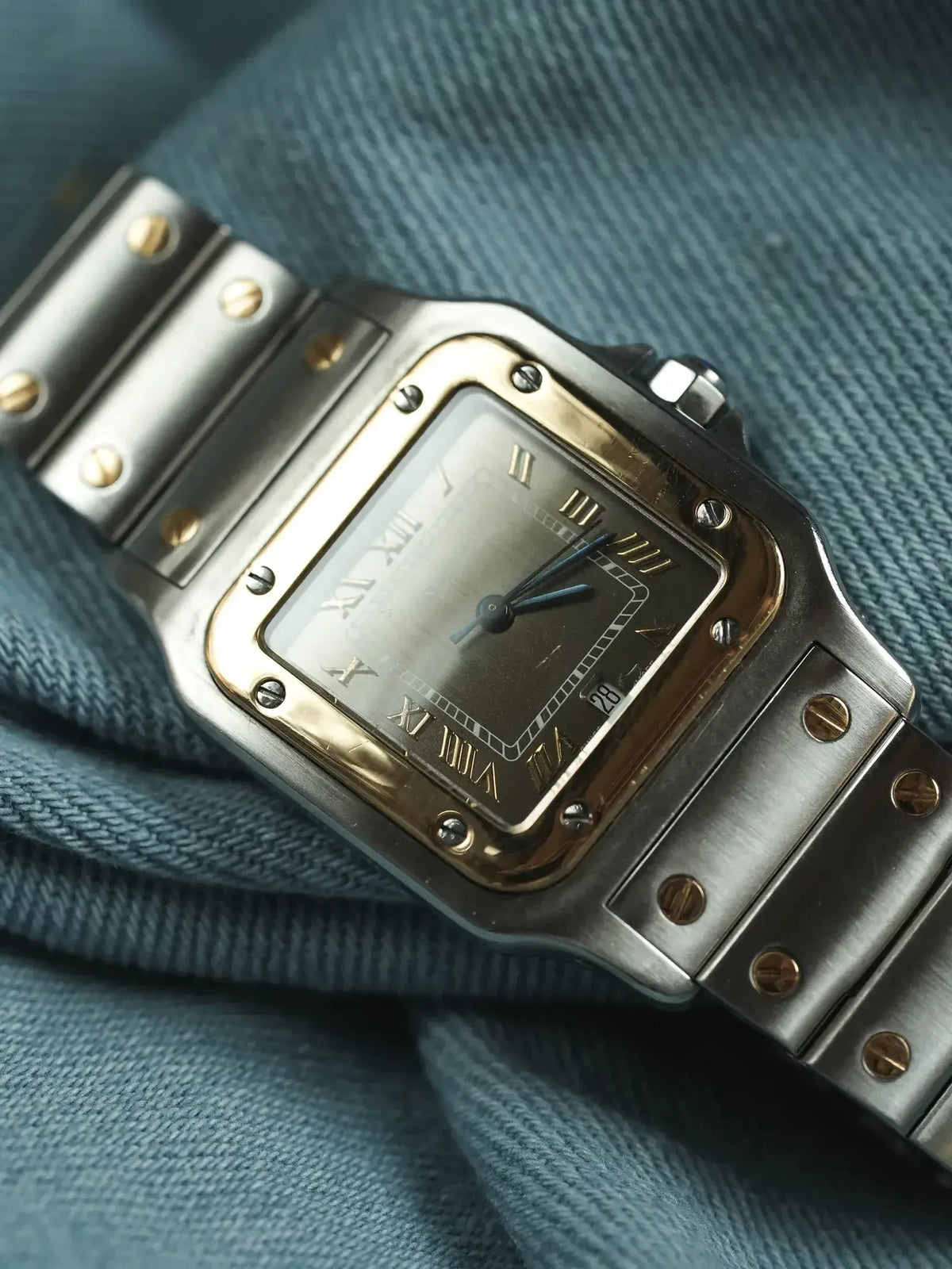 Cartier Santos vintage watch with two-tone steel and gold case, gray dial, Roman numerals on fabric