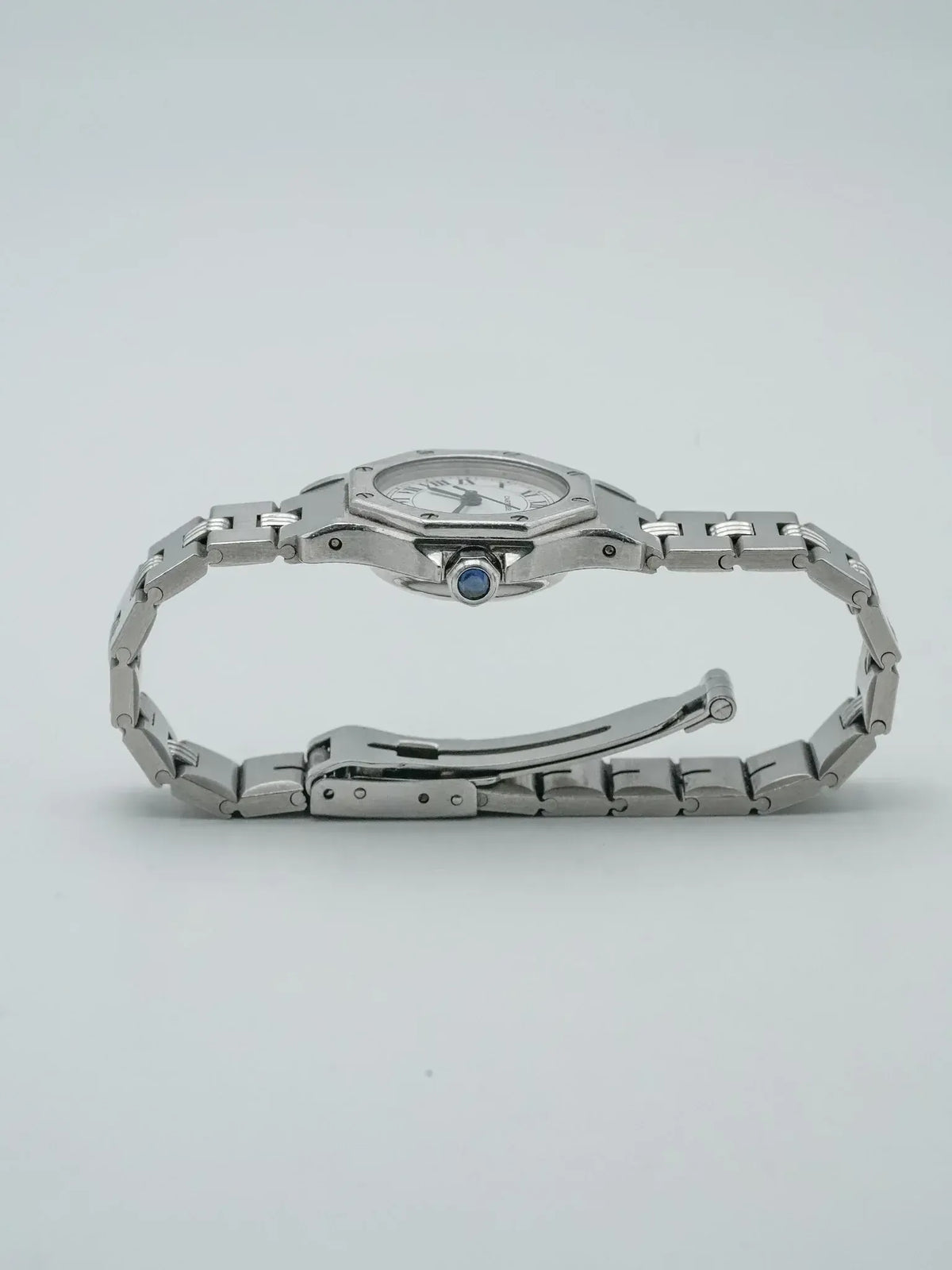 Cartier Panthère vintage watch with steel bracelet and blue cabochon crown on white background