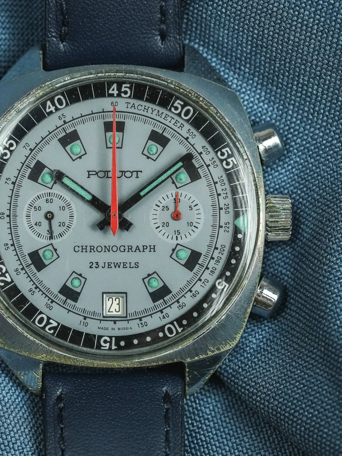 Poljot vintage chronograph watch with silver dial, red seconds hand, and blue leather strap