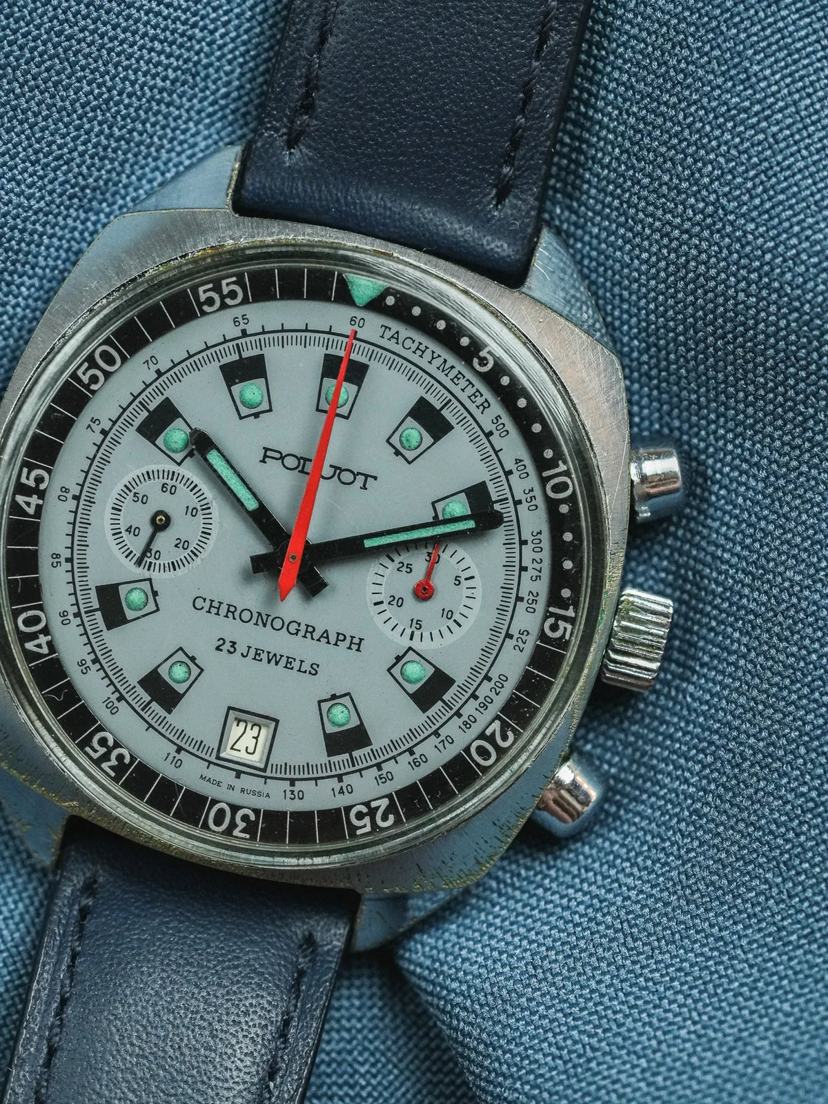 Poljot vintage chronograph watch with grey dial, red seconds hand, and blue leather strap