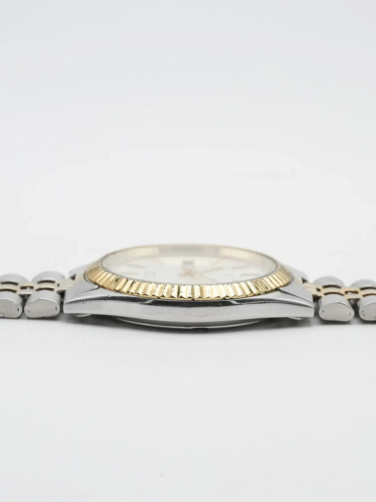 Rolex vintage two-tone watch with fluted bezel, silver dial, on white background