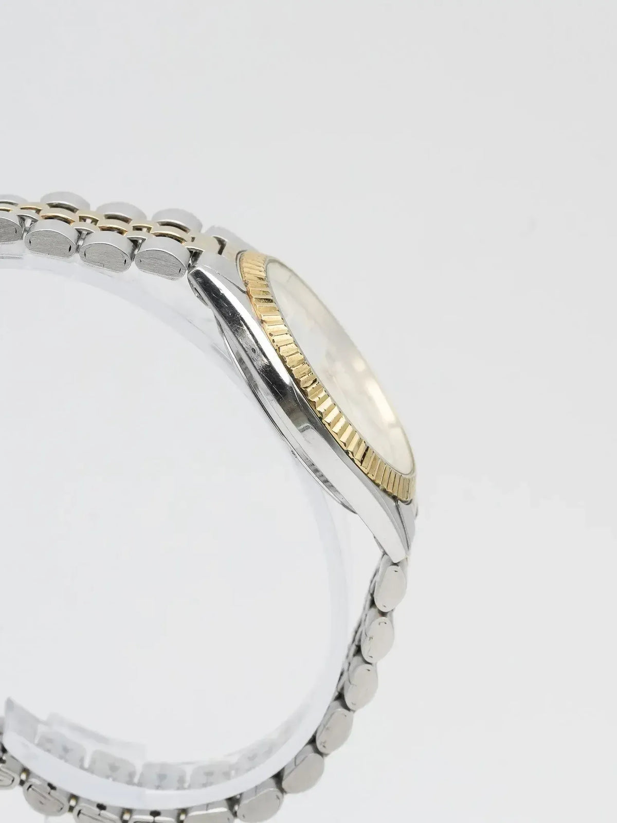 Rolex vintage two-tone watch with fluted bezel and Jubilee bracelet on white background