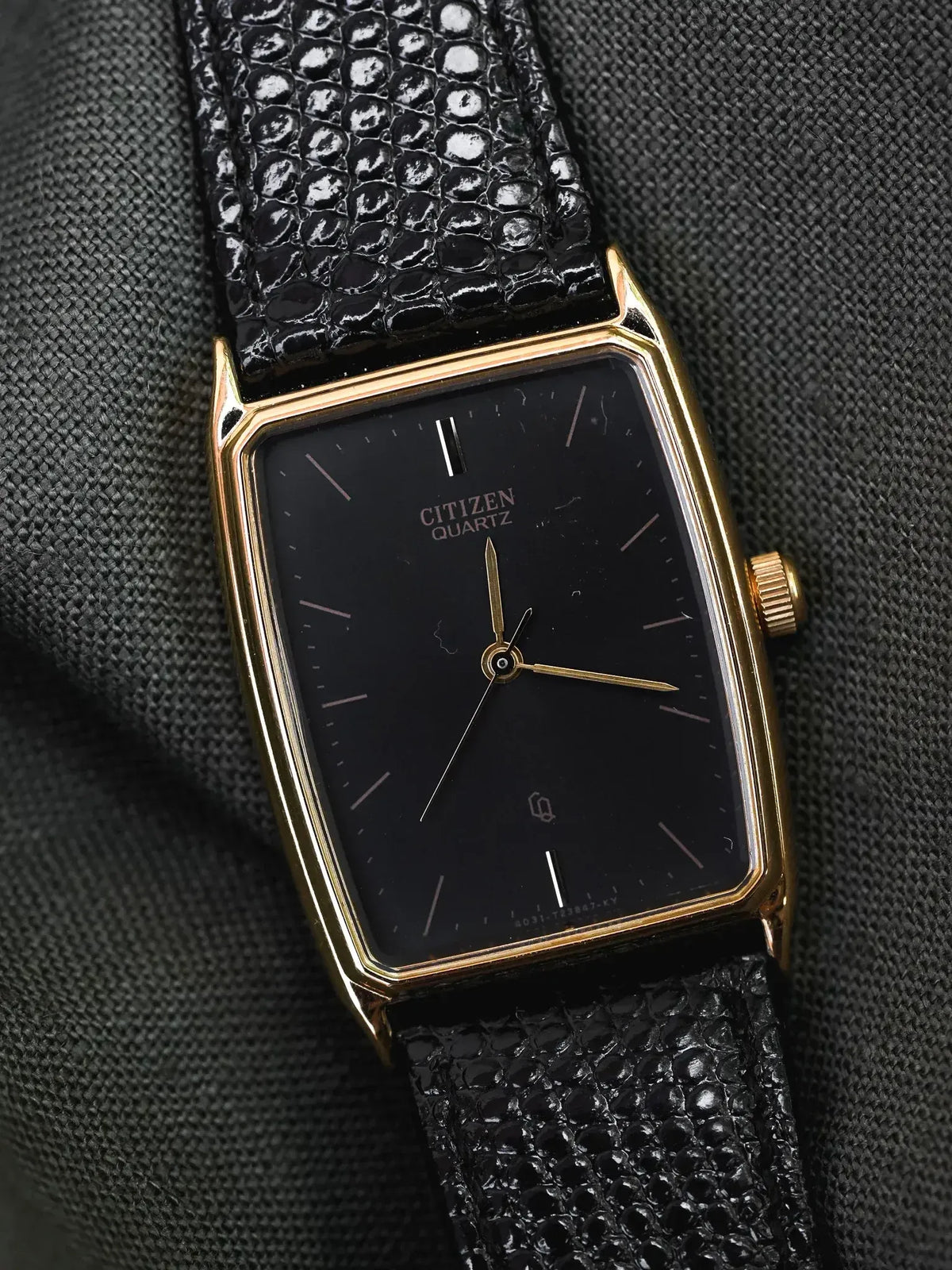 Citizen Quartz vintage watch with gold case, black dial, and textured black strap