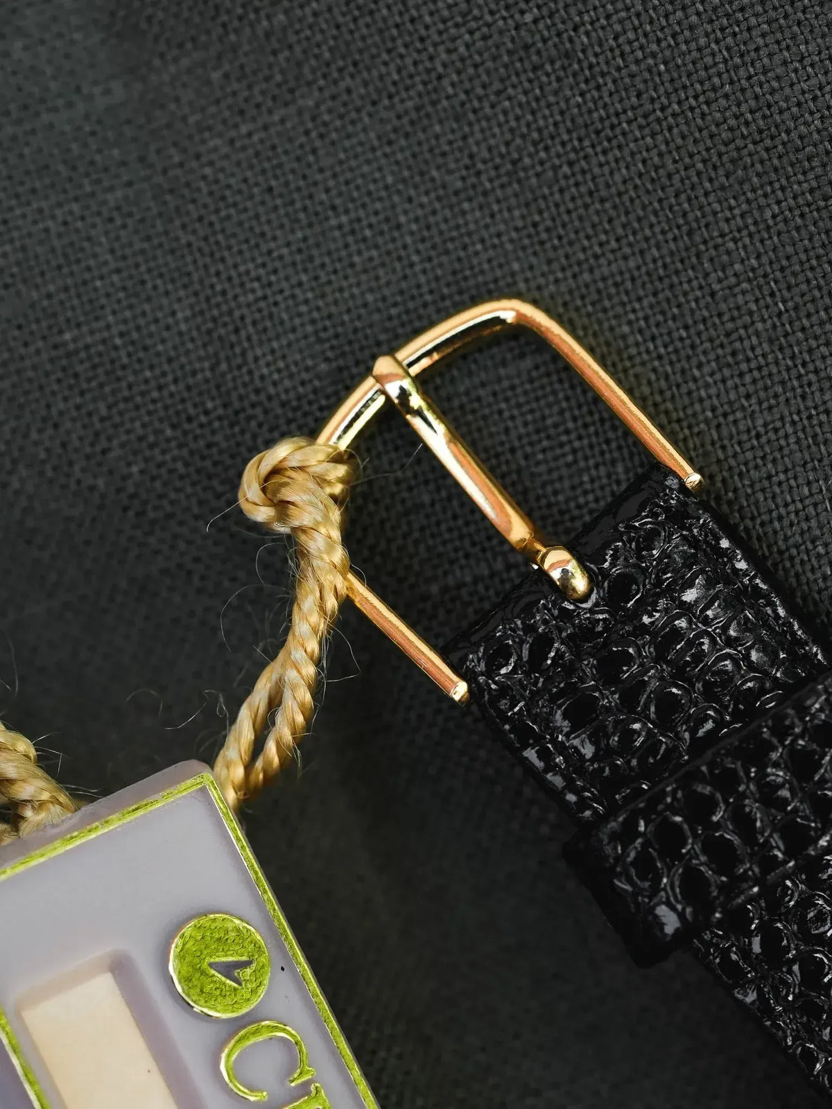 Black alligator leather strap with gold buckle, vintage watch accessory detail