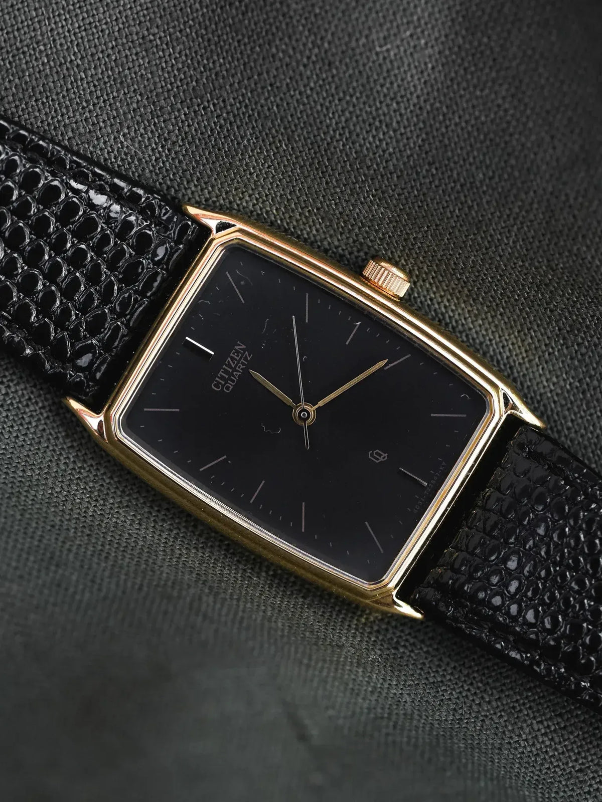 Citizen Quartz vintage watch with gold case, black dial, and textured leather strap