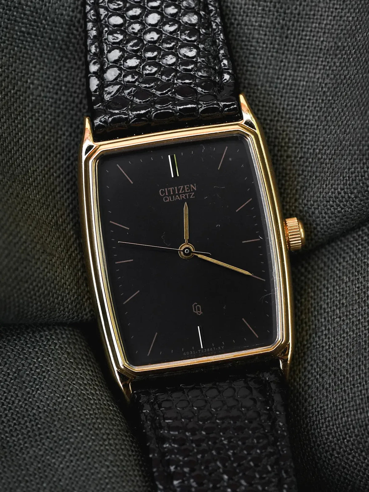 Citizen Quartz vintage watch with gold case, black dial, and textured black strap