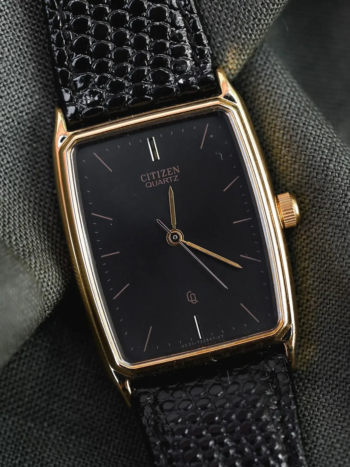 Citizen Quartz vintage watch with gold case, black dial, and textured black strap