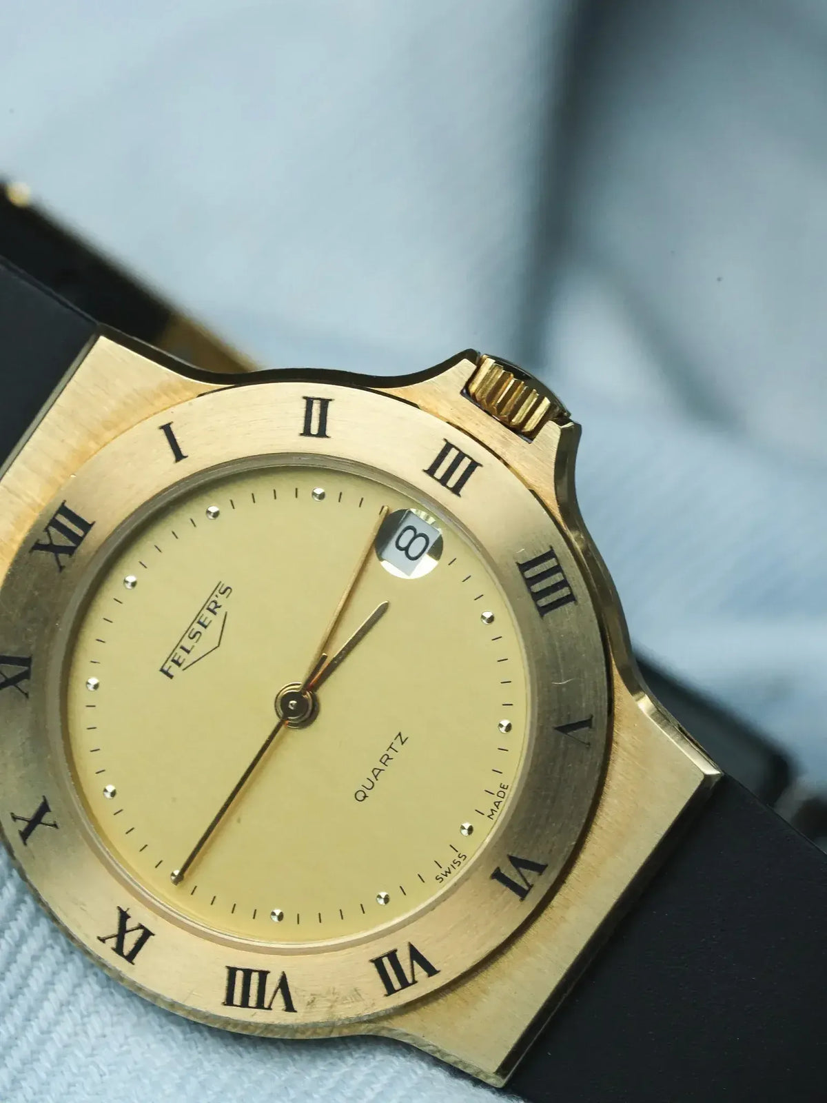 Felser's vintage quartz watch, gold case, cream dial with Roman numerals, black strap