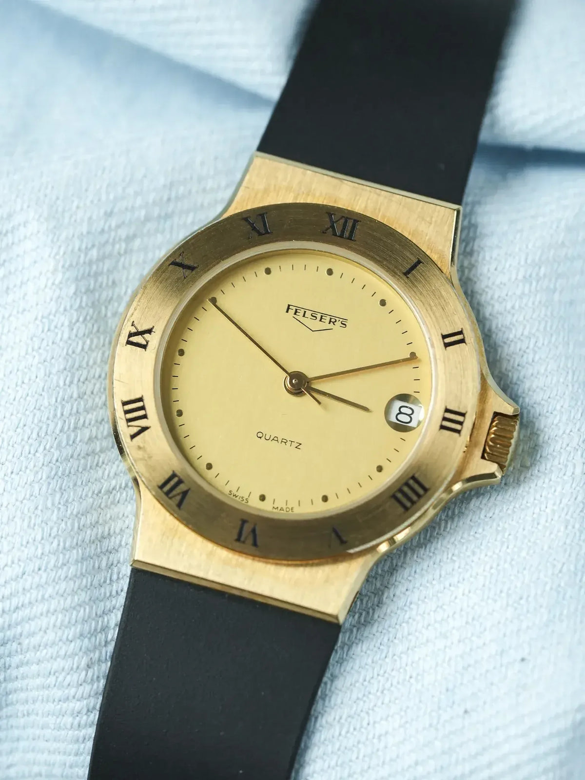 Felser's vintage quartz watch, gold case, cream dial, black strap, Roman numerals