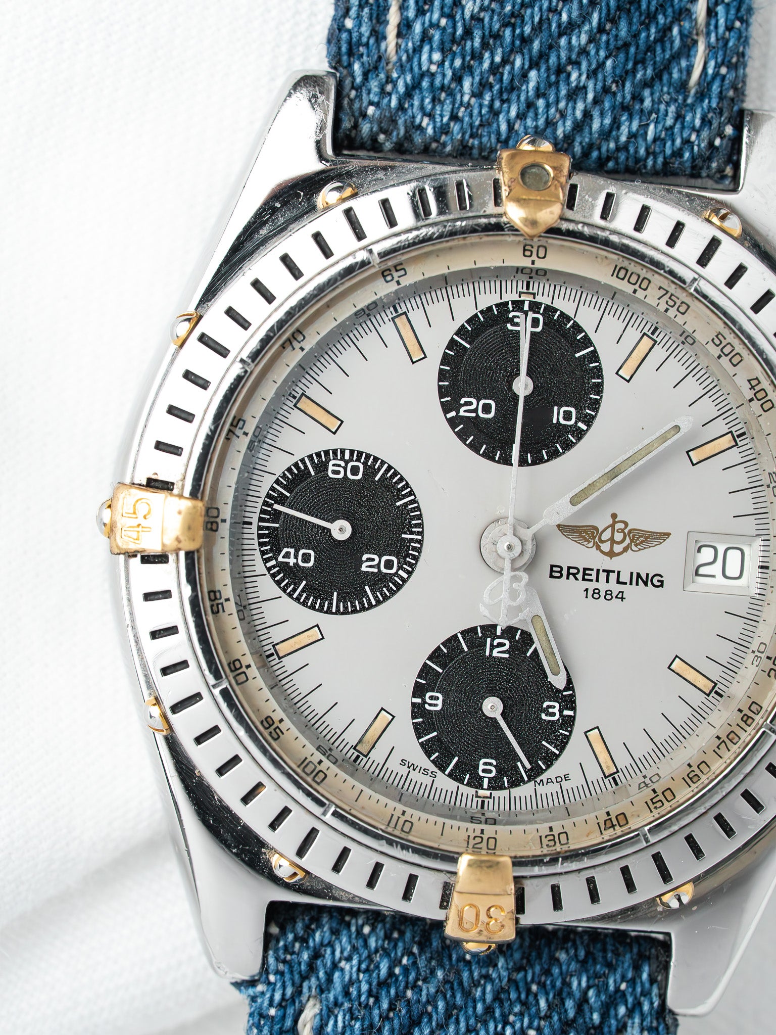 Breitling chronograph vintage with silver dial, black subdials, and denim strap