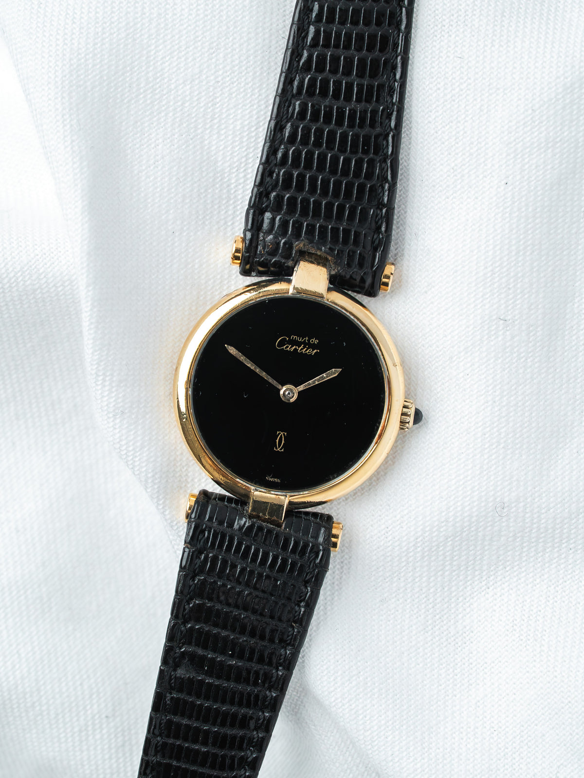 Cartier Must de Cartier vintage watch with gold case, black dial, and black lizard strap