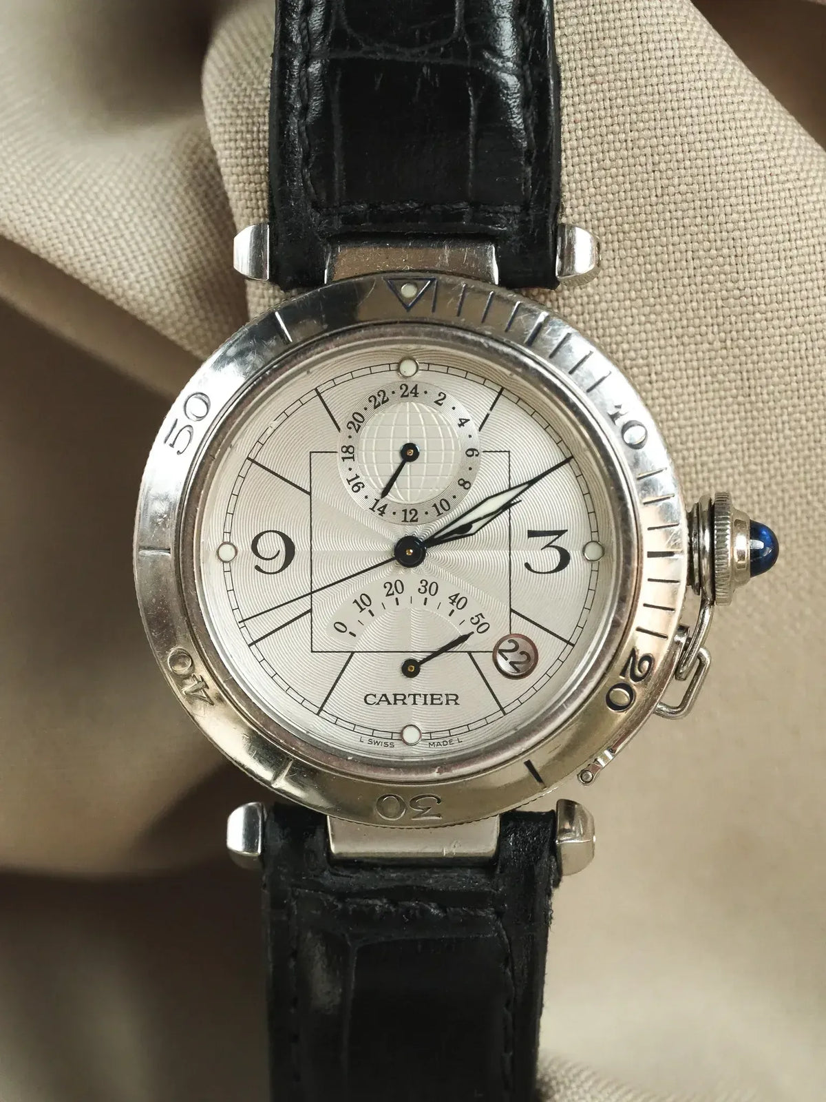 Cartier Pasha vintage watch with silver dial, black leather strap, and blue cabochon crown
