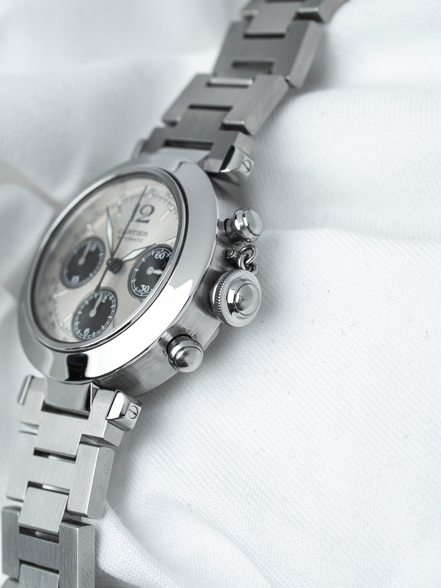 Cartier chronograph watch with silver dial, steel bracelet, and polished case