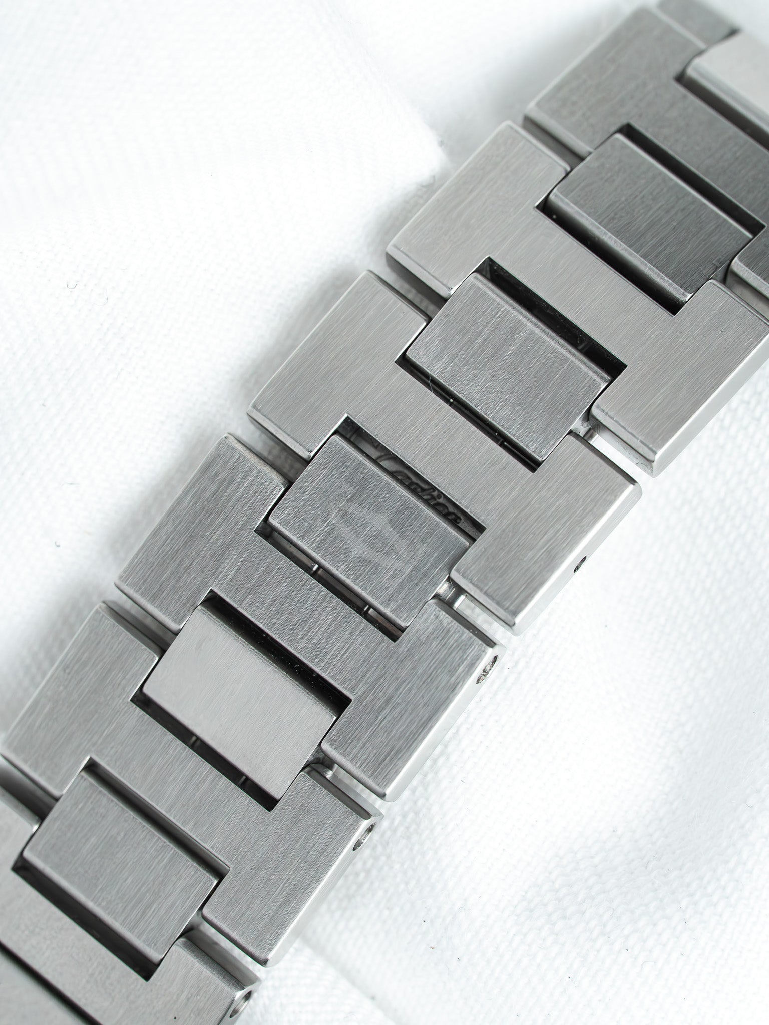 Cartier vintage bracelet watch with brushed steel links on white background