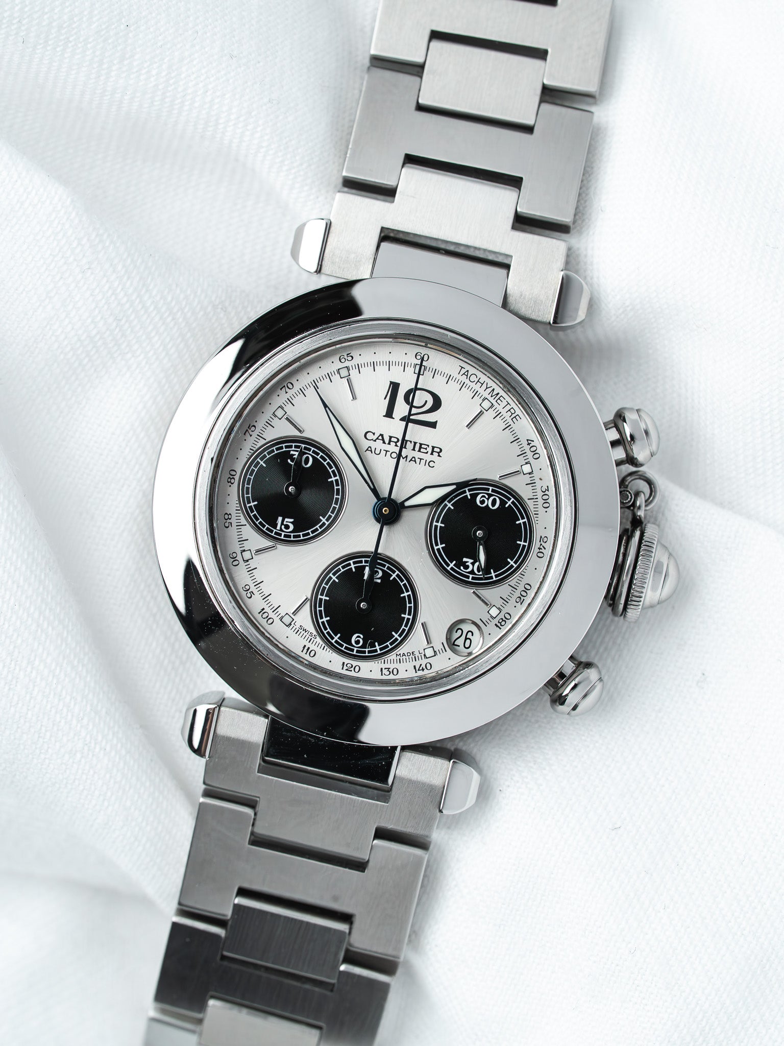 Cartier chronograph watch with silver dial, black subdials, and steel bracelet