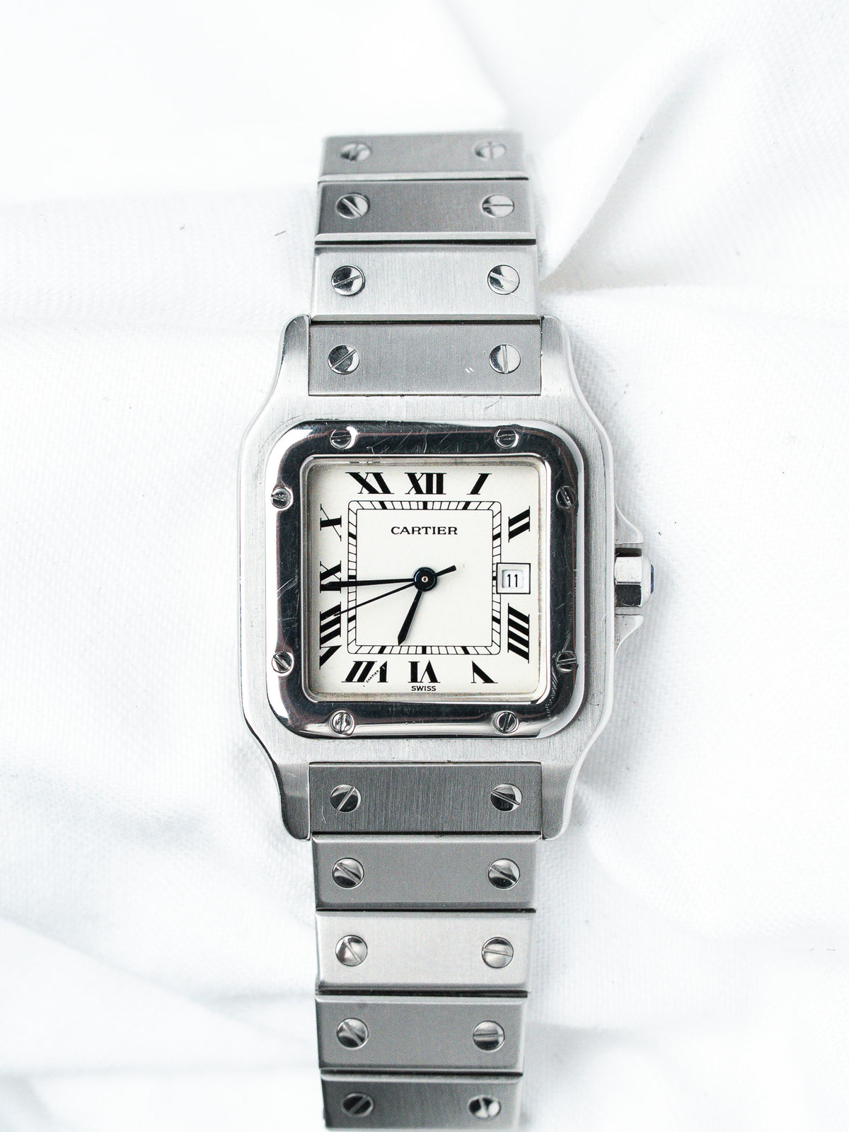 Cartier Santos vintage watch with white dial, Roman numerals, and steel bracelet