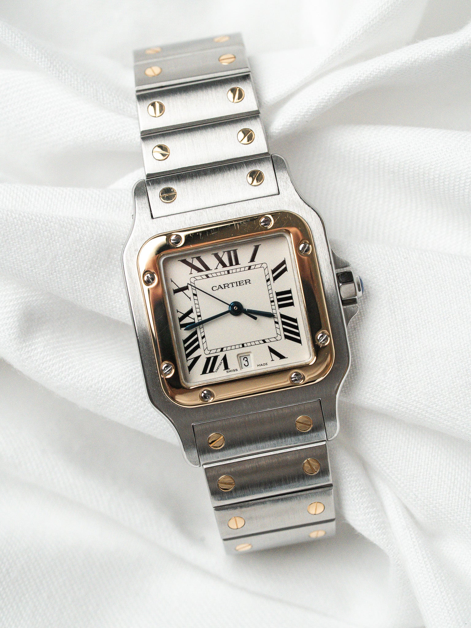 Cartier Santos watch with steel and gold case, white dial, Roman numerals on fabric