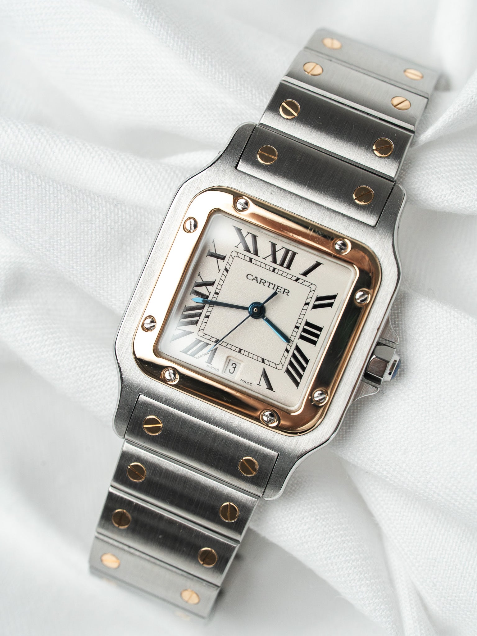 Cartier Santos watch with steel and rose gold case, white dial, Roman numerals on fabric