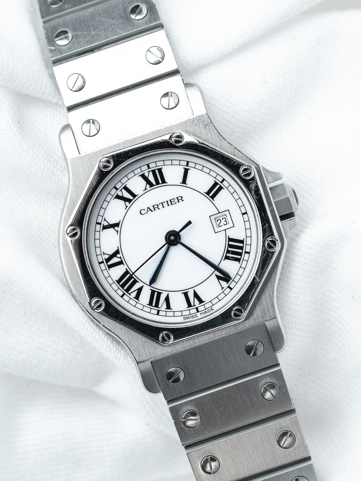 Cartier Santos watch with white dial, Roman numerals, and steel bracelet