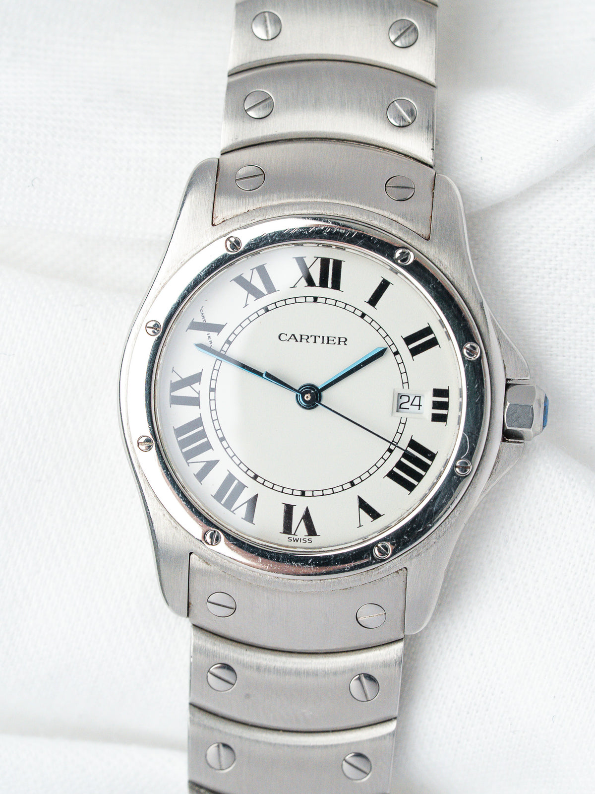 Cartier Santos watch with white dial, Roman numerals, steel bracelet on white background