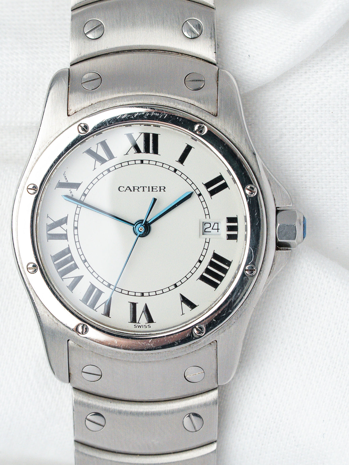 Cartier Santos watch with white dial, Roman numerals, and steel bracelet on white background
