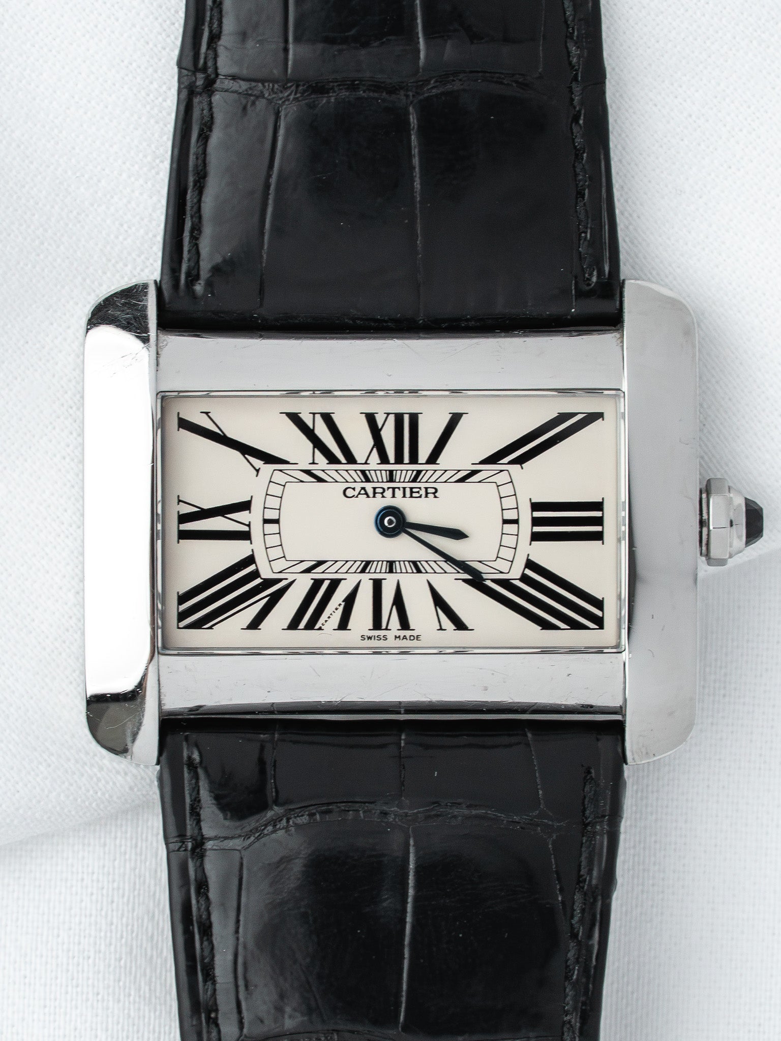 Cartier Tank watch with white dial, Roman numerals, black alligator strap, and steel case