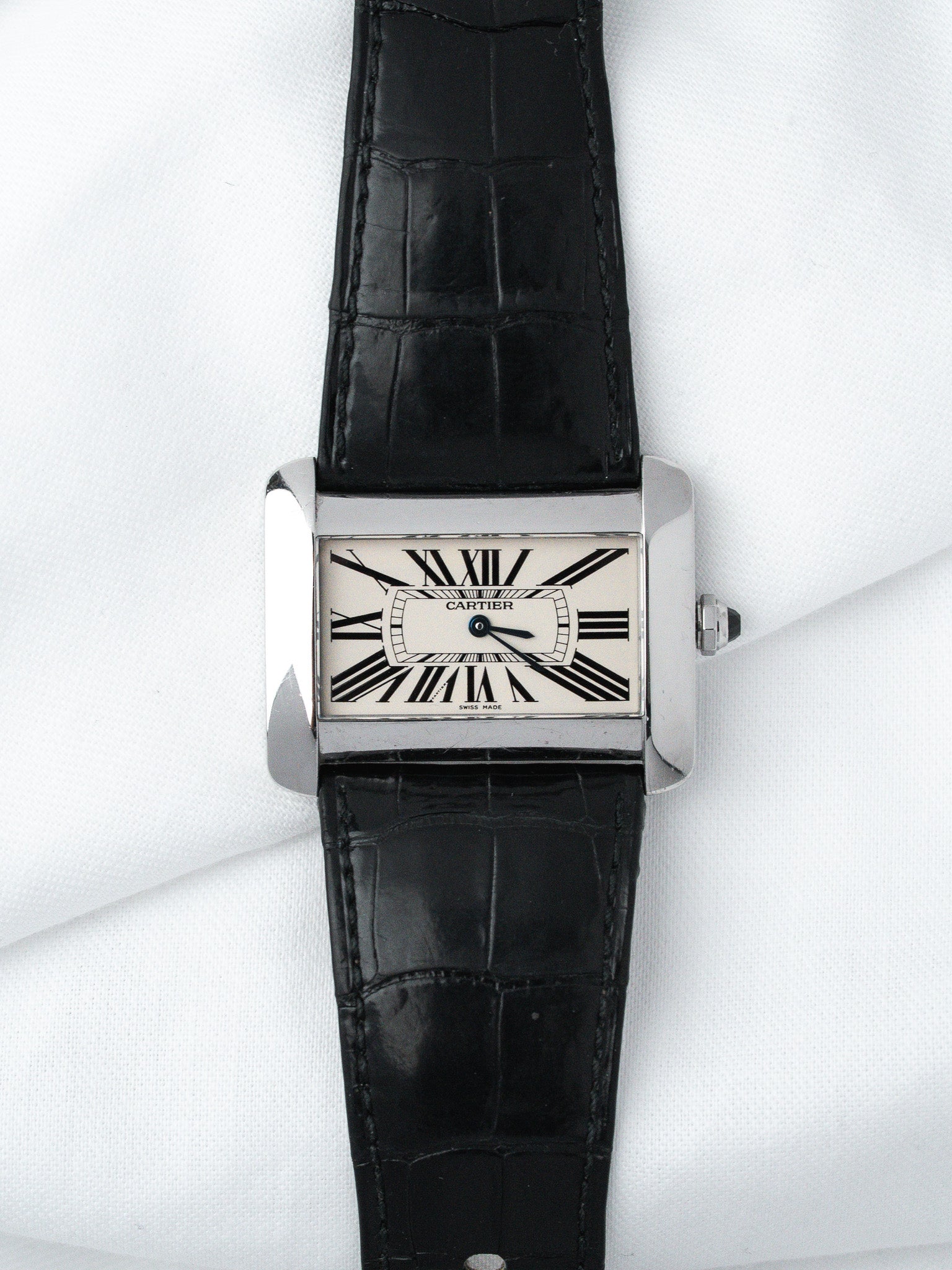 Cartier Tank watch with white dial, black Roman numerals, and black alligator strap
