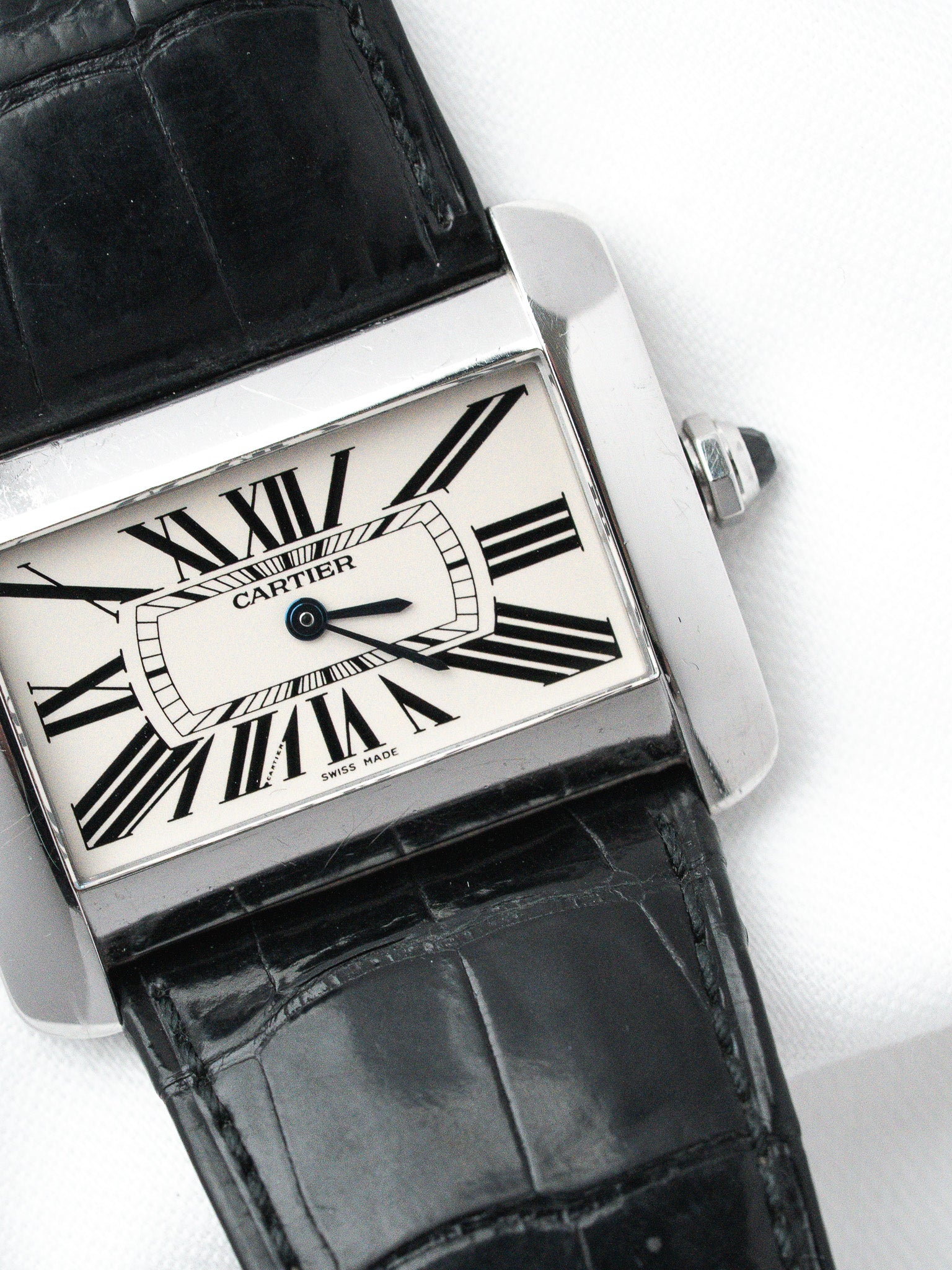 Cartier Tank vintage watch with white dial, black Roman numerals, and black alligator strap