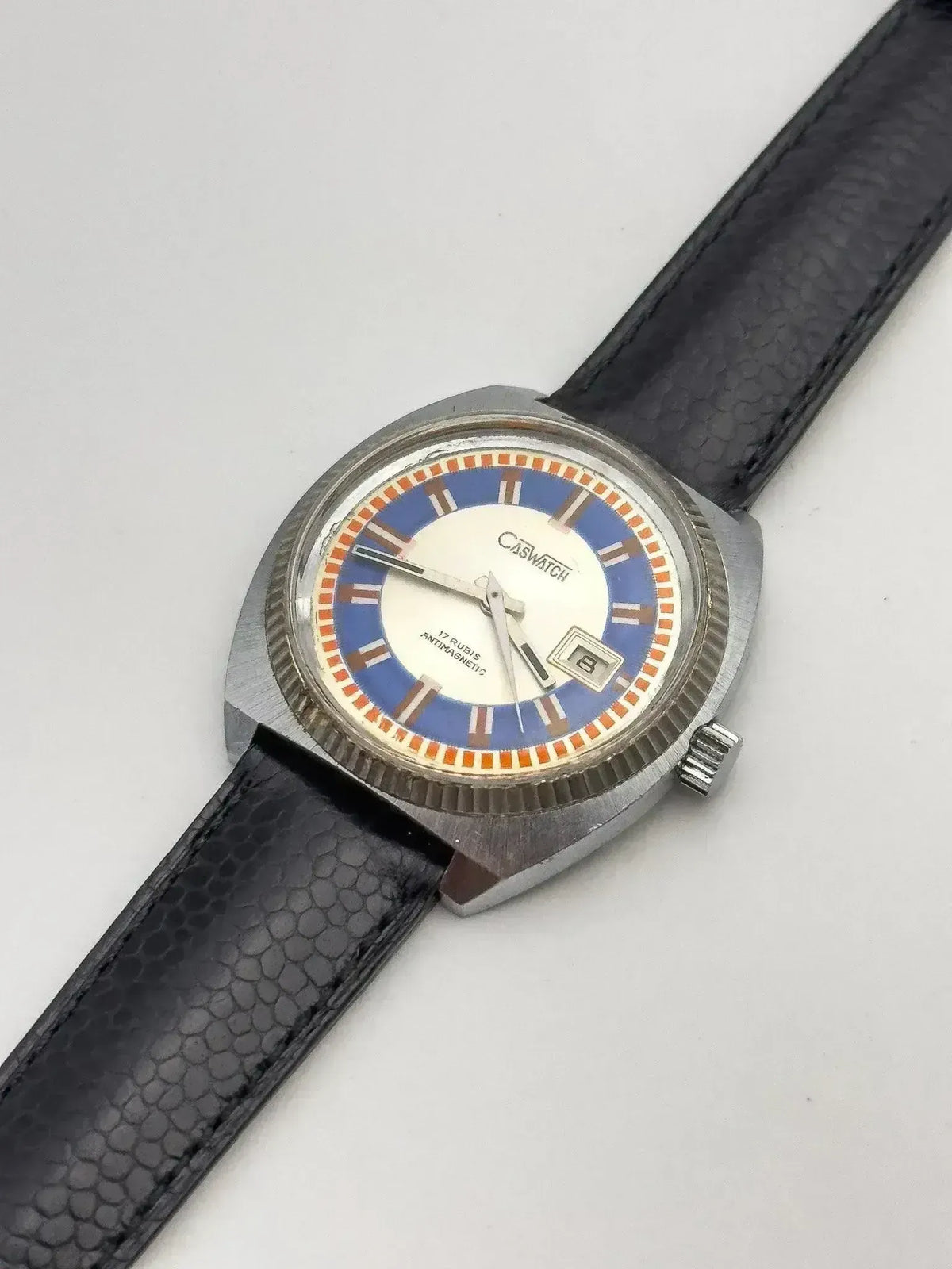 Caswatch vintage watch with blue and orange dial, black textured strap, stainless steel case