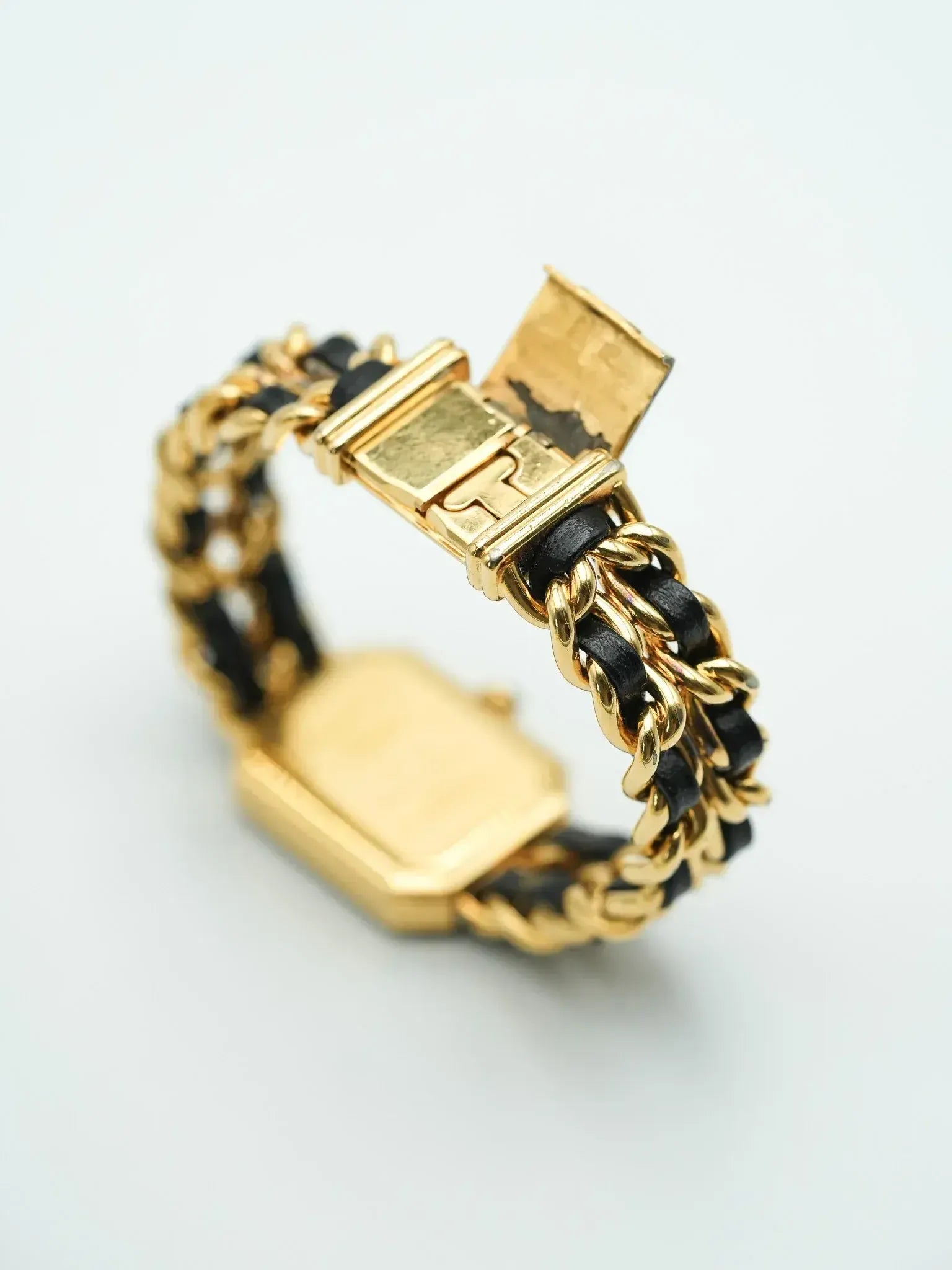 Vintage Cartier watch with gold case and black leather chain bracelet