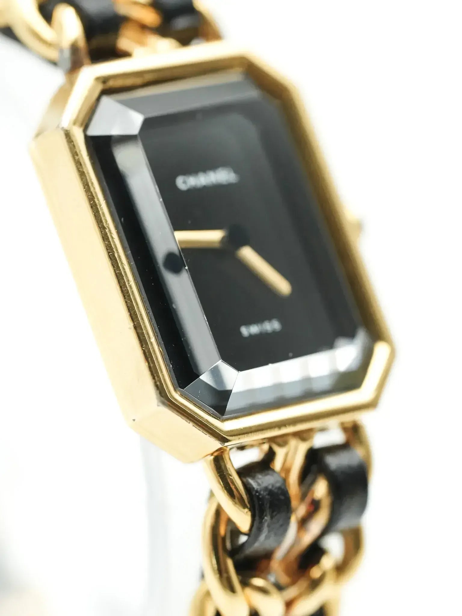 Cartier vintage watch with gold case, black dial, and chain-link bracelet
