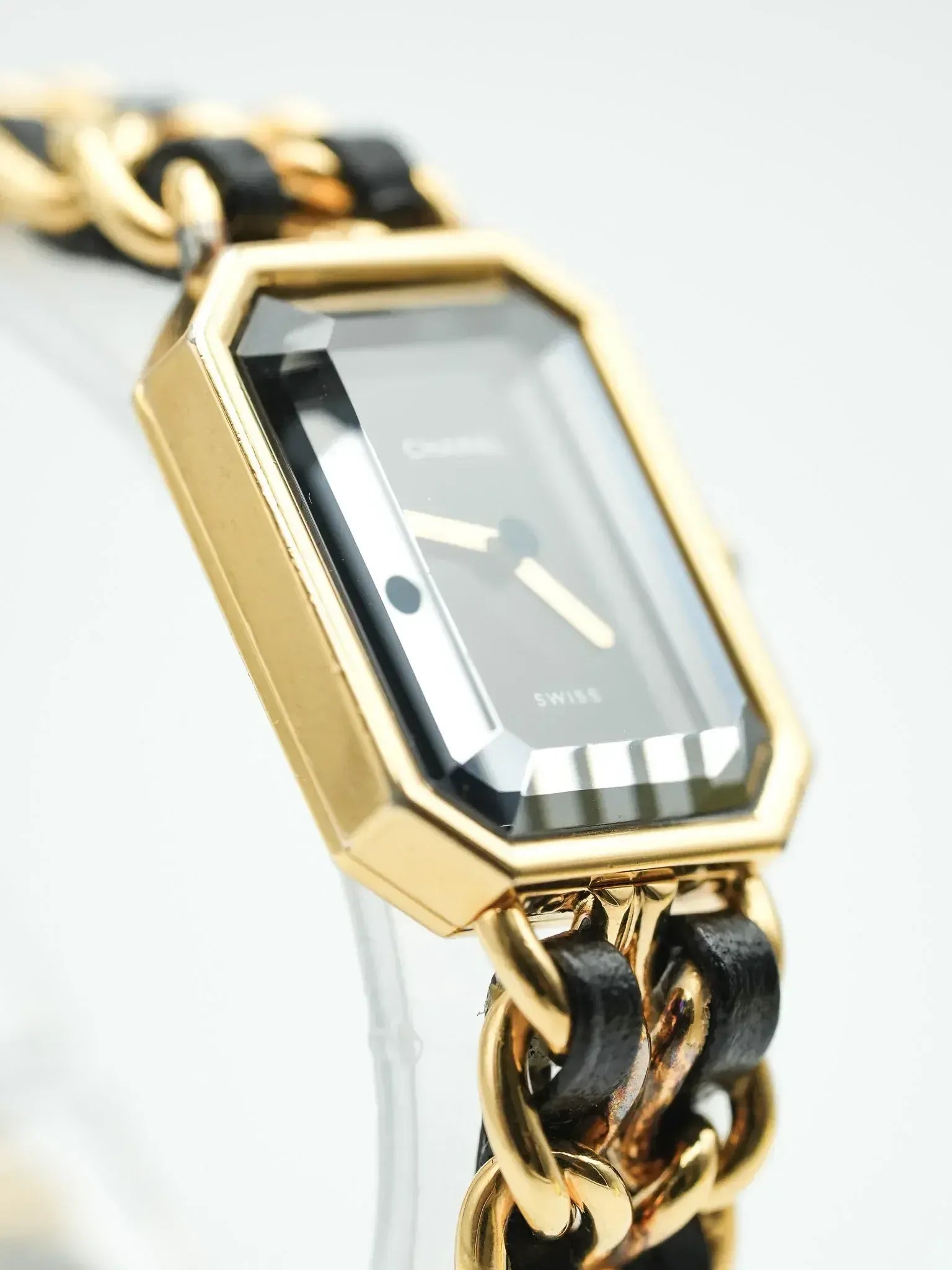 Chanel vintage watch with gold octagonal case, black dial, and chain-link bracelet