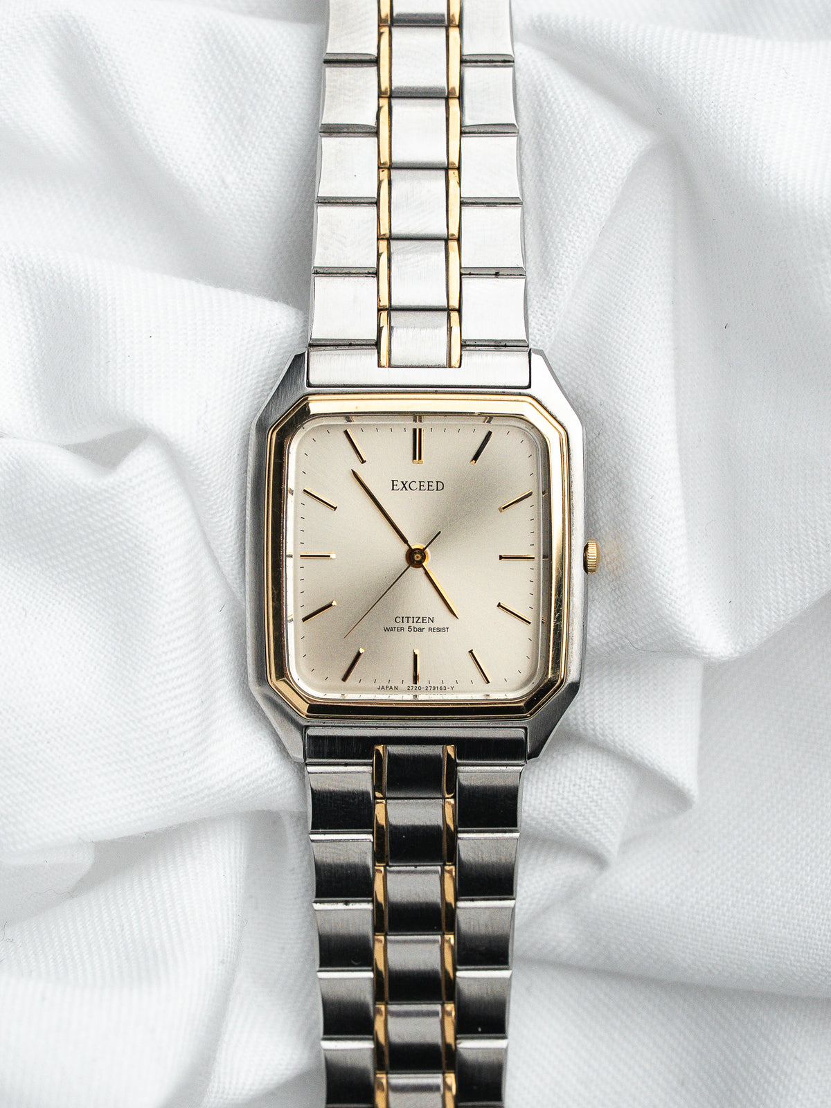 Montre Citizen Exceed vintage avec cadran champagne et bracelet bicolore argent et or.