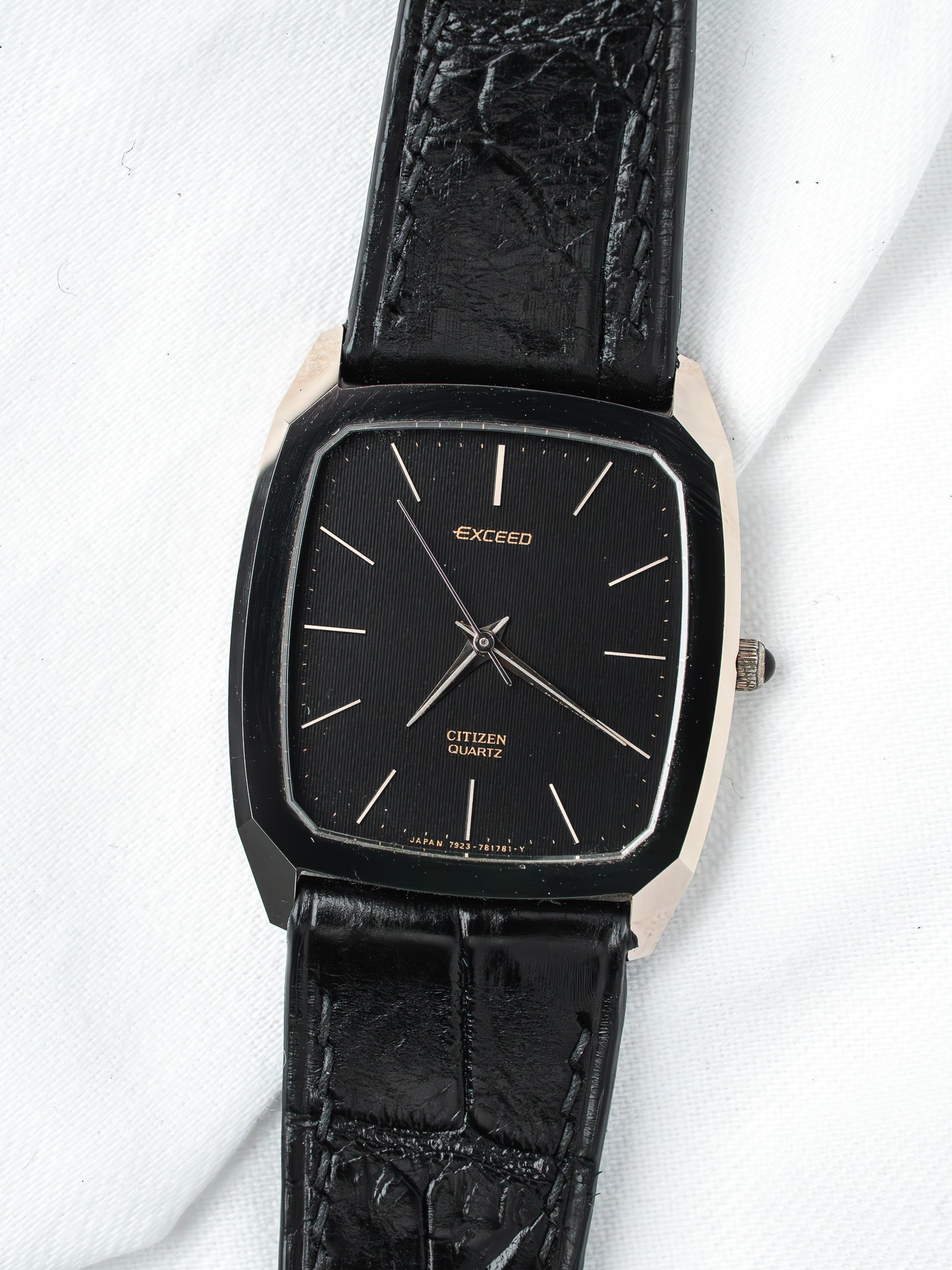 Citizen Exceed vintage watch with black dial, gold accents, and textured leather strap