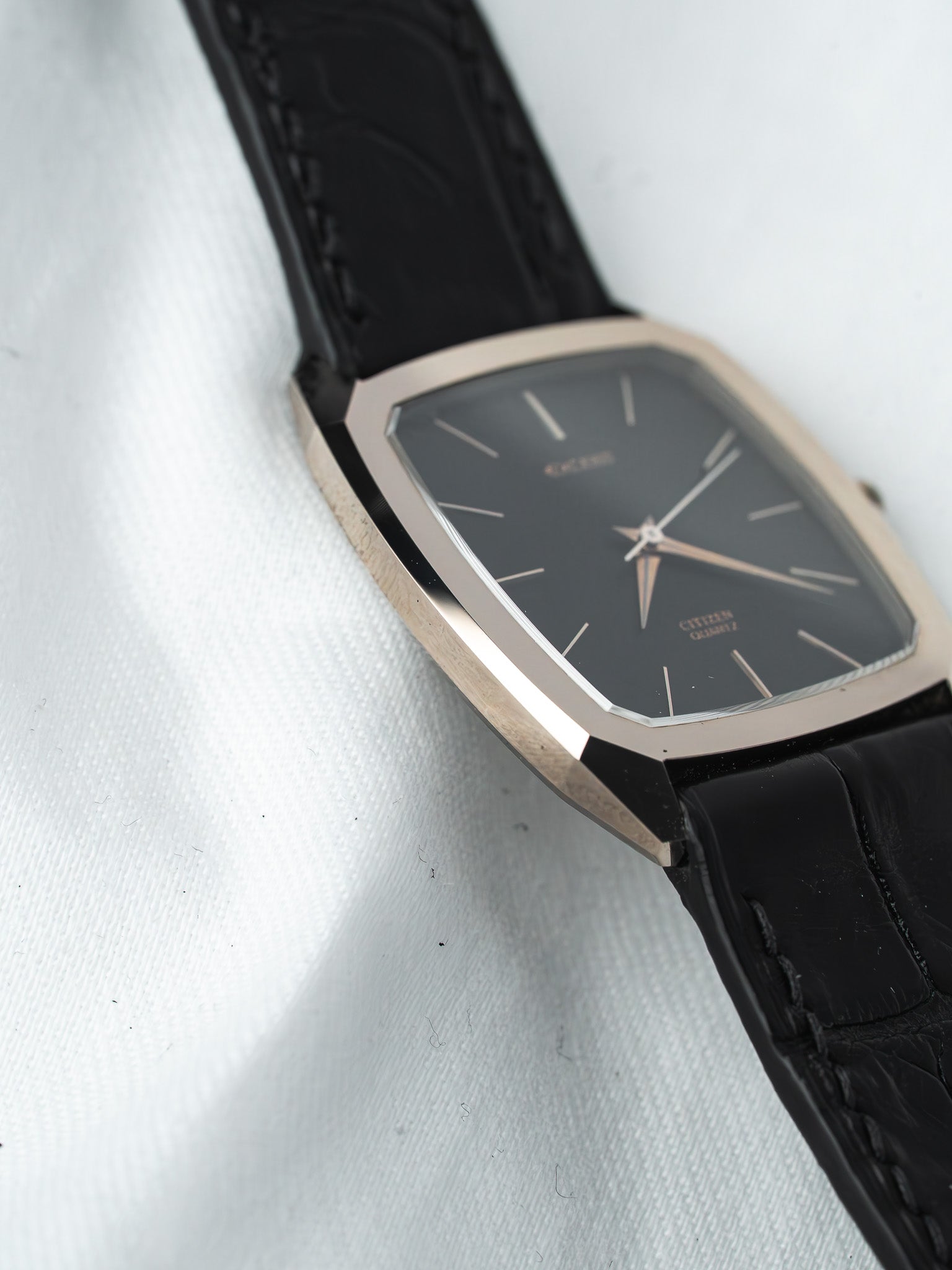 Citizen Quartz vintage watch with black dial, gold-tone case, and black leather strap