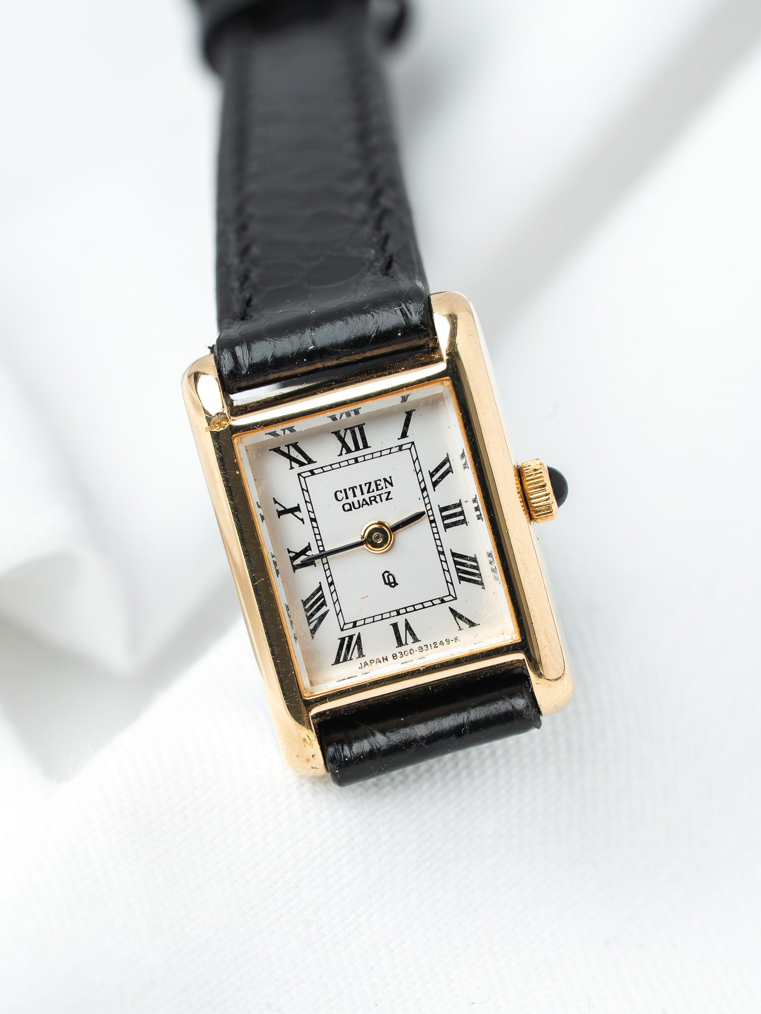 Citizen Quartz vintage watch with gold case, white dial, Roman numerals, black leather strap