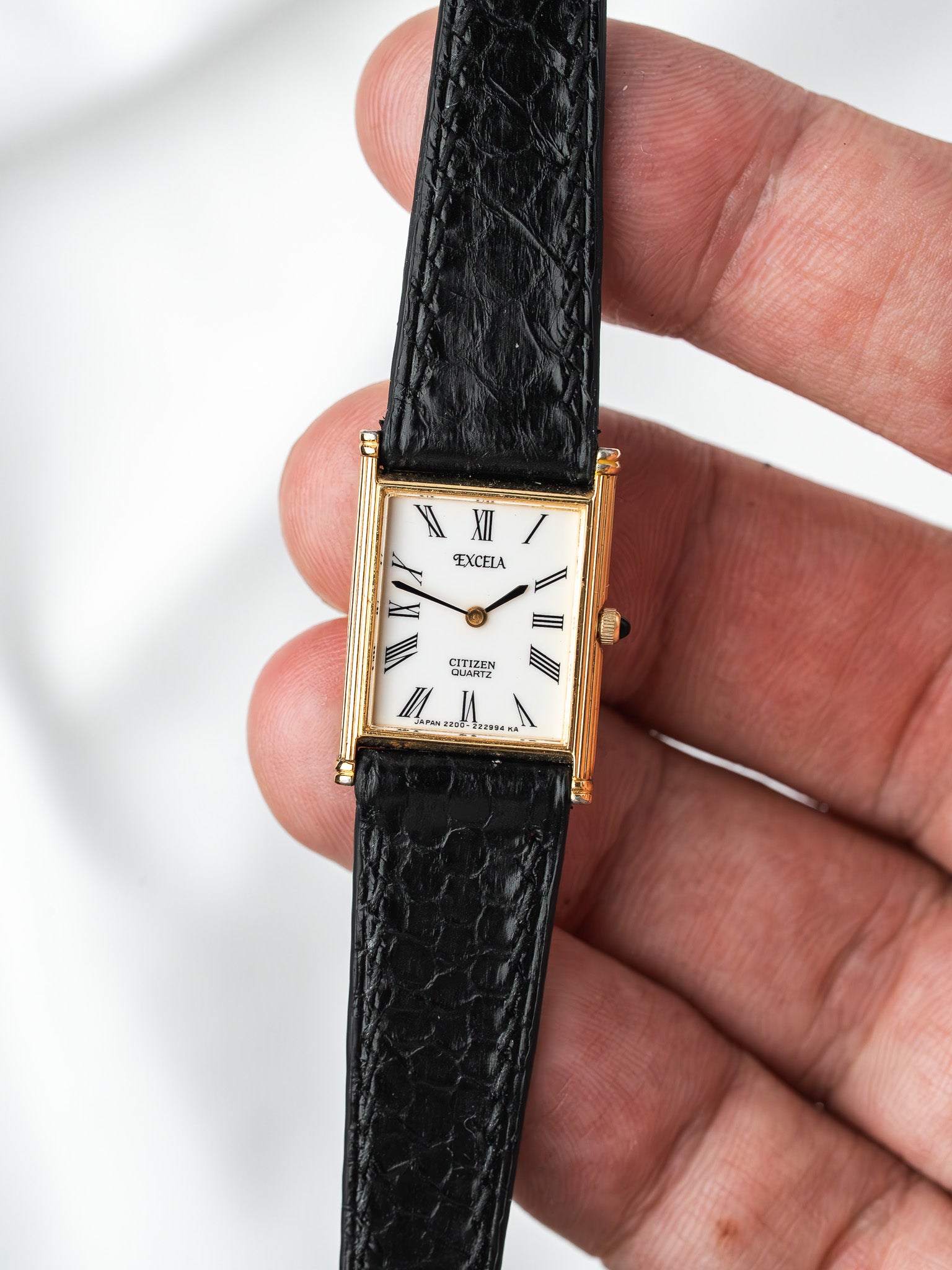 Citizen Excella vintage watch with gold case, white dial, Roman numerals, black leather strap