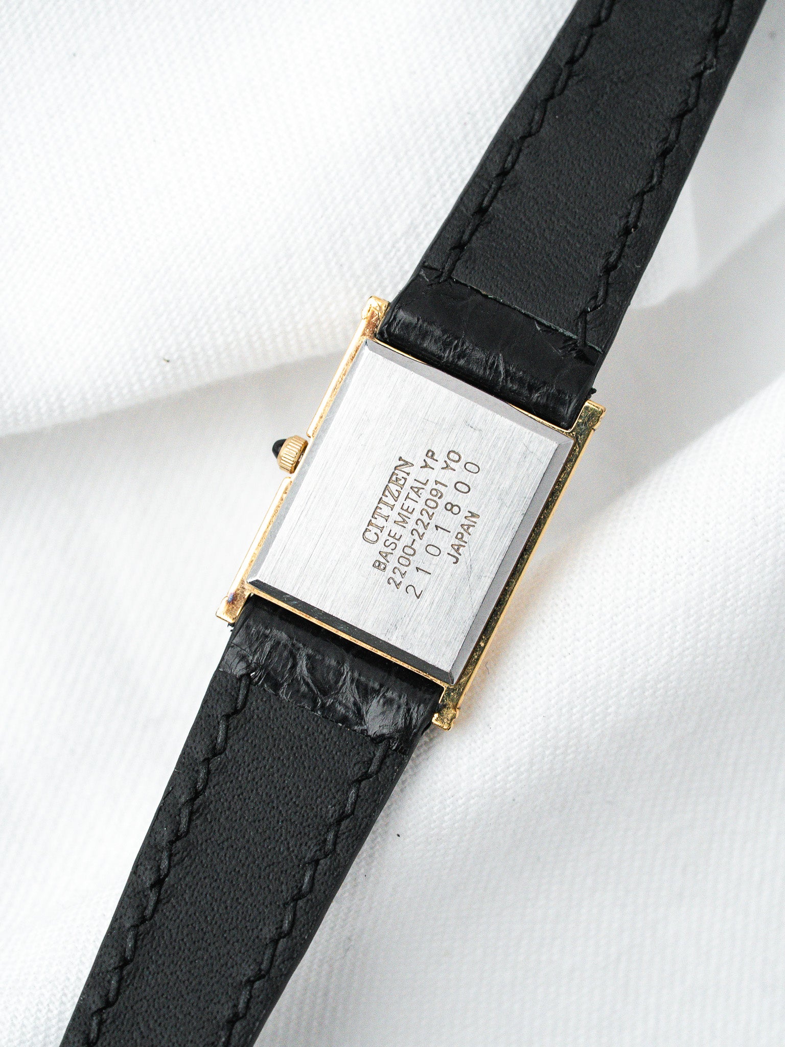 Citizen vintage watch with gold-tone case, black leather strap, and engraved back