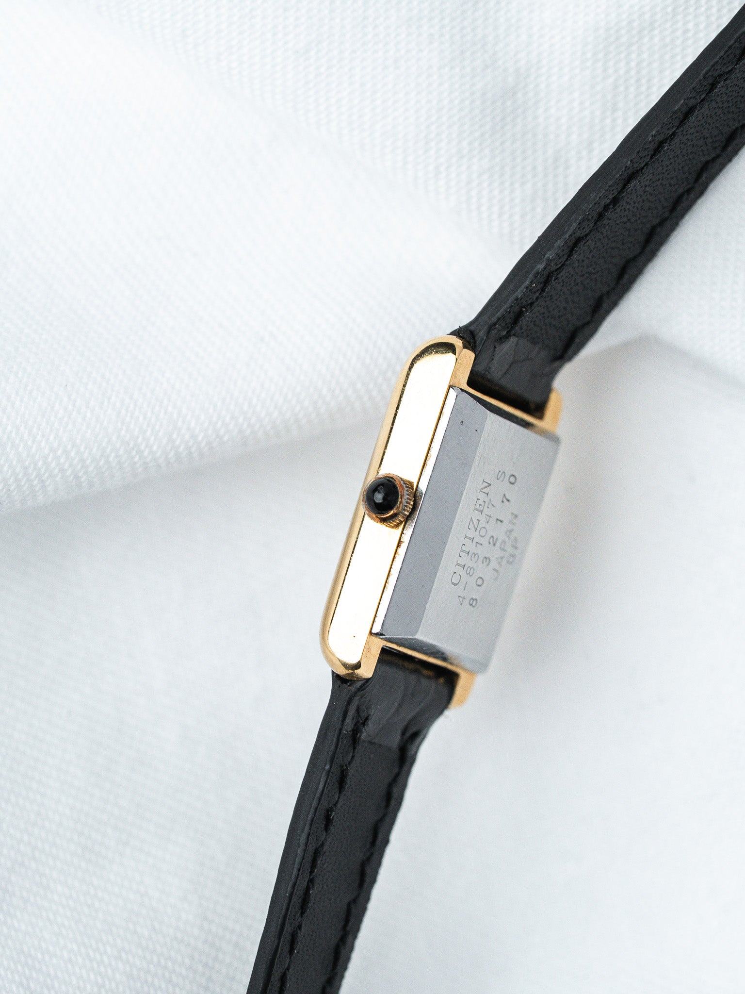 Citizen vintage watch with gold-tone case, black leather strap, and engraved back