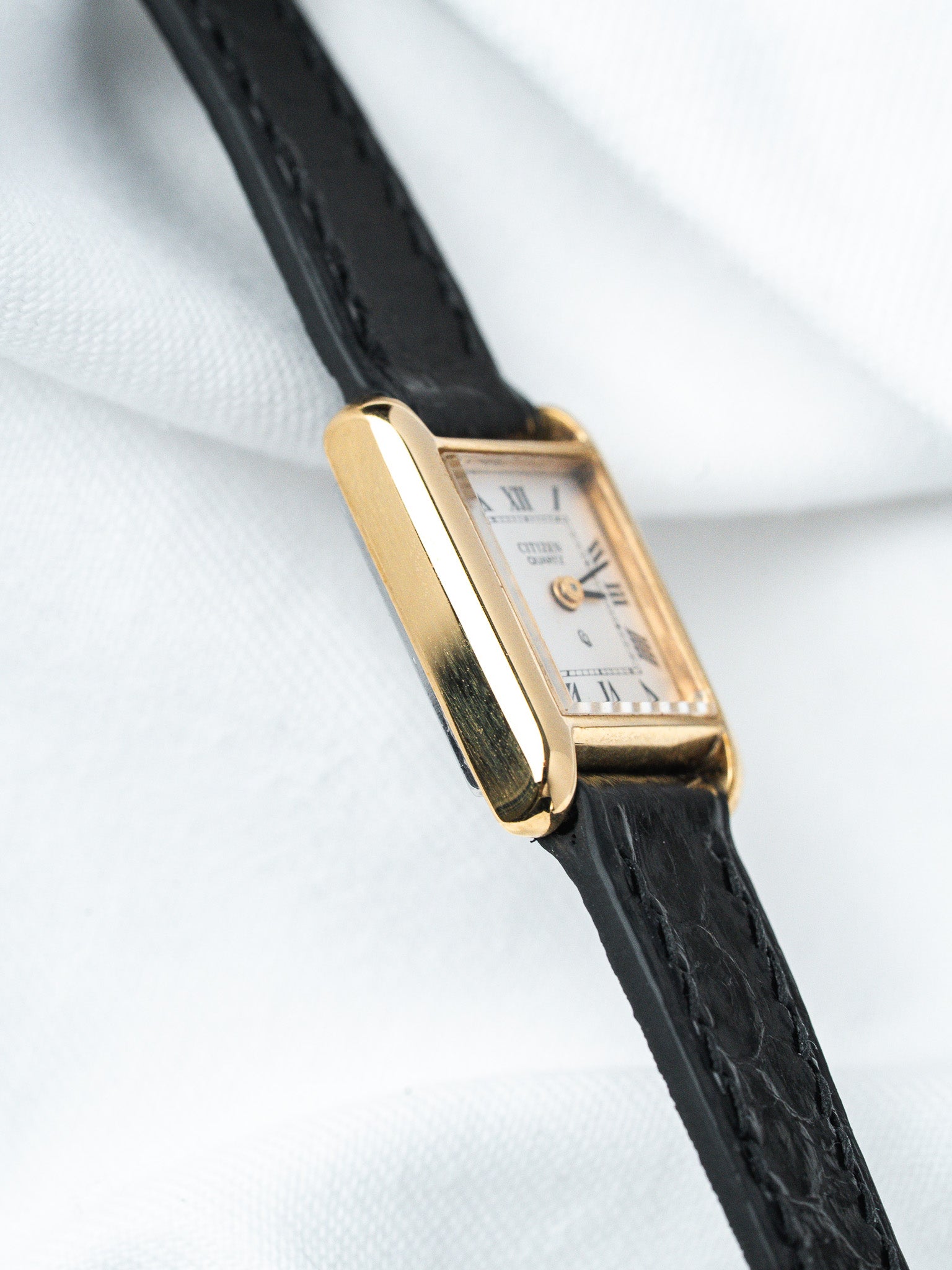 Citizen Quartz vintage watch with gold case, white dial, Roman numerals, black leather strap