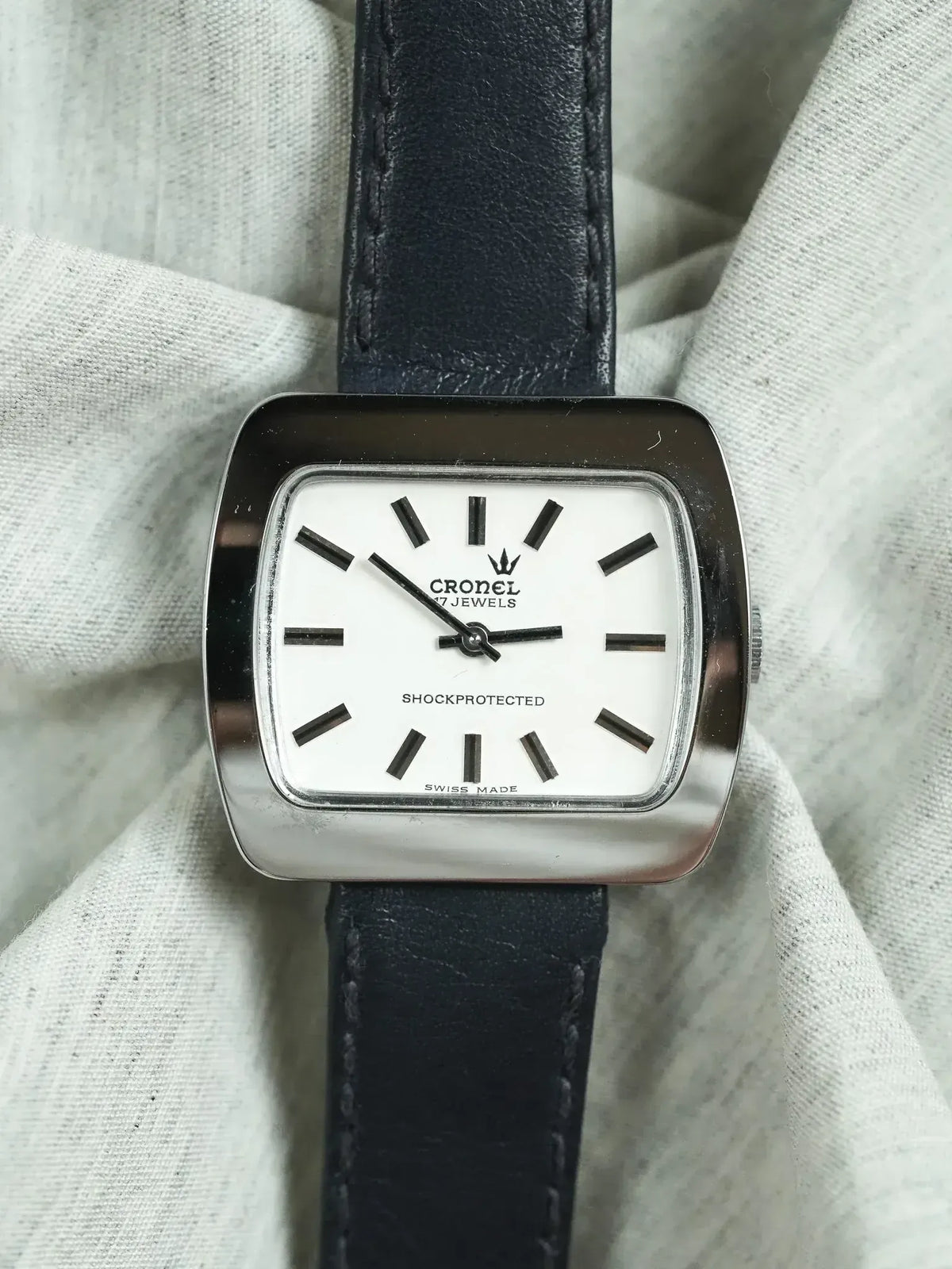 Cronel vintage watch with white dial, black markers, and black leather strap