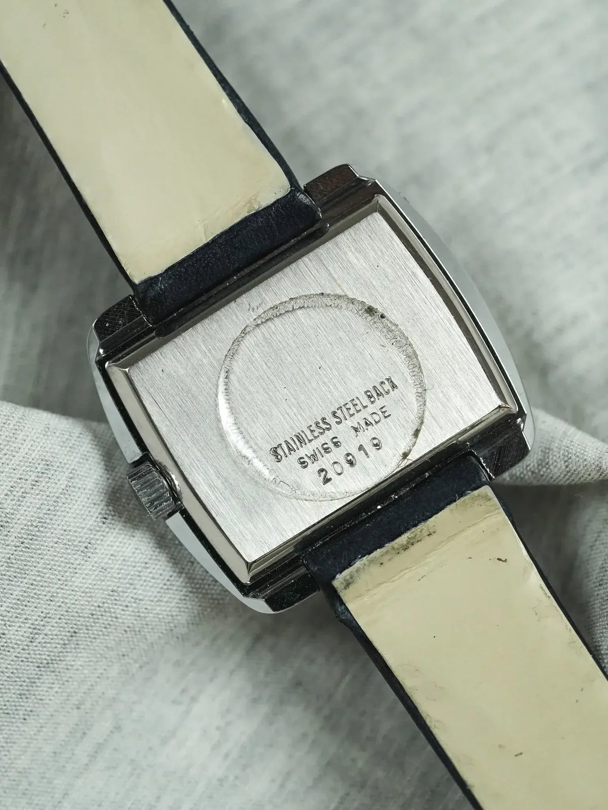 Vintage stainless steel watch back, Swiss made, model 20919, cream leather strap