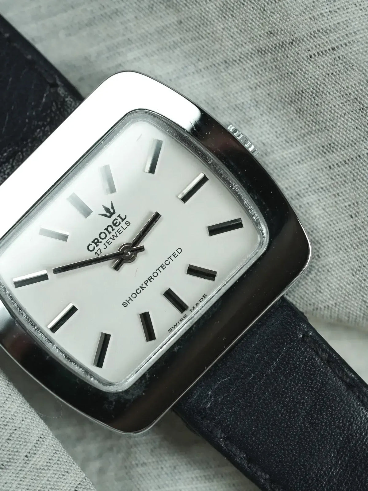 Cronel vintage watch with white dial, black markers, and black leather strap